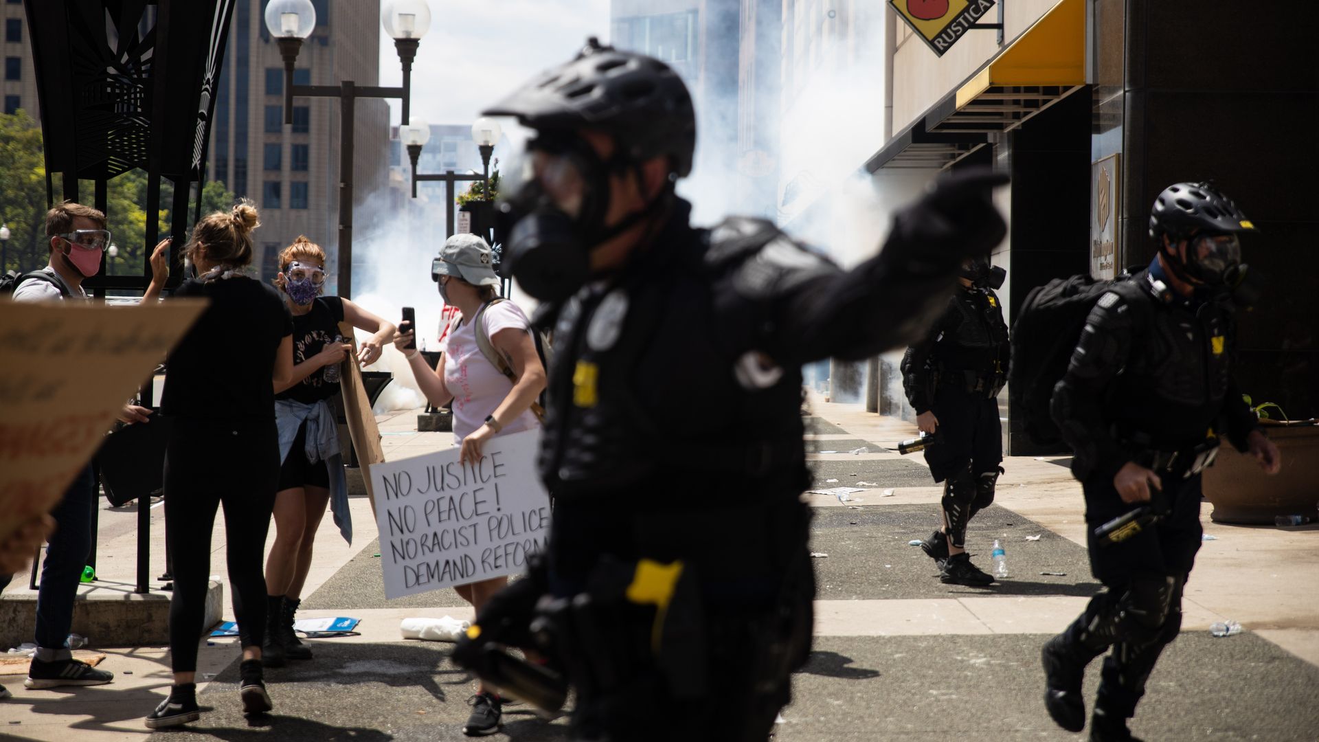 Police and protesters are seen amid a cloud of tear gas during a 2020 protest in Columbus.