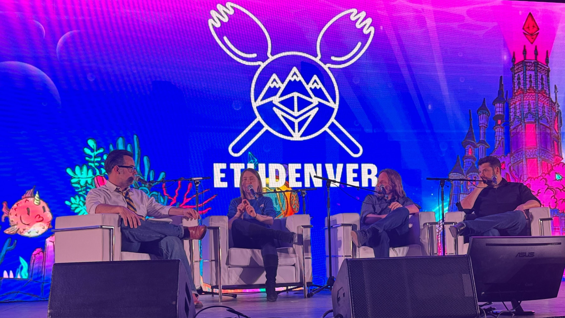 Axios Crypto's Brady Dale on a stage at ETHDenver with panelists