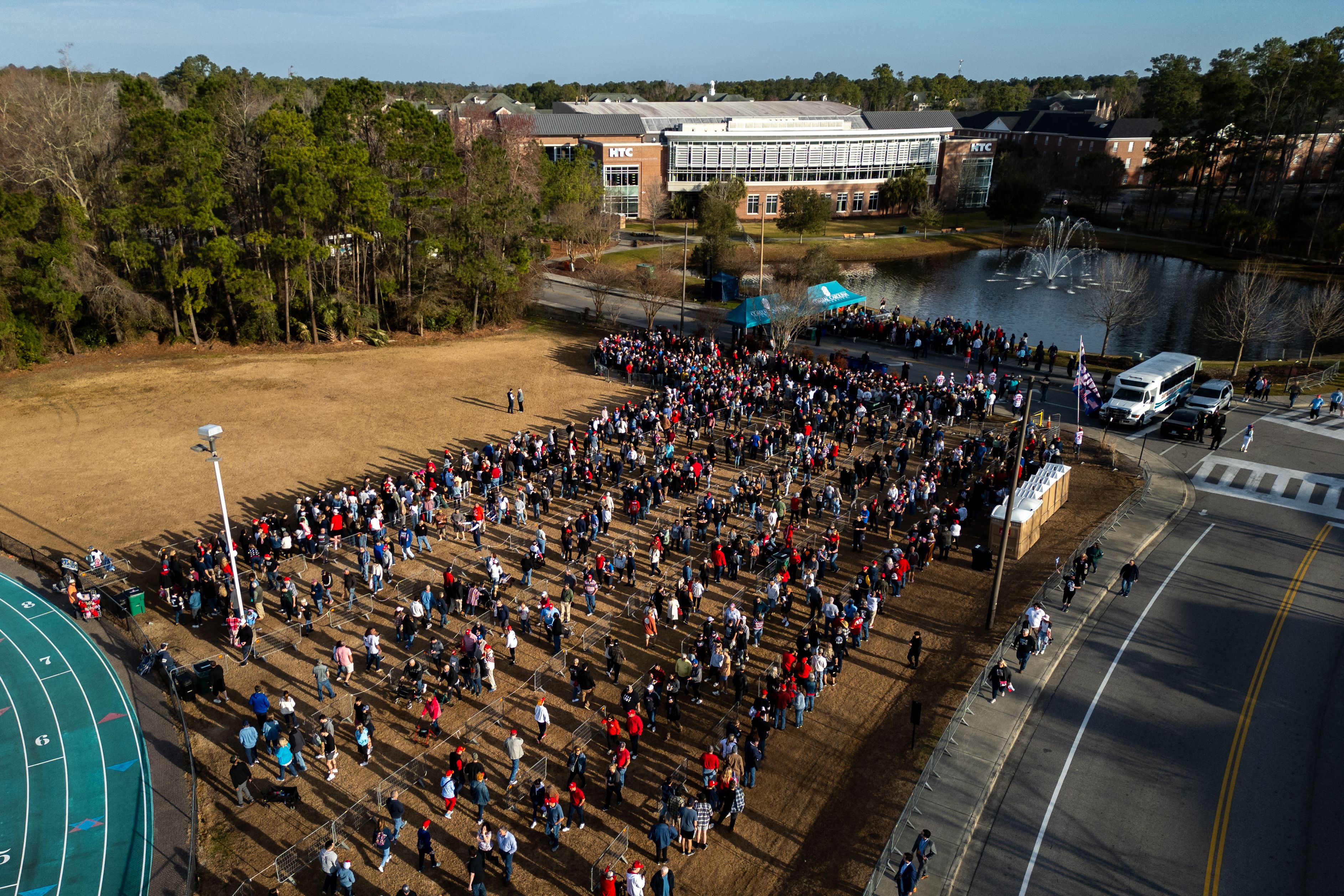 In an aerial view, supporters of former US President and 2024 presidential hopeful Donald Trump wait to enter a "Get Out the Vote" rally in Conway, South Carolina,