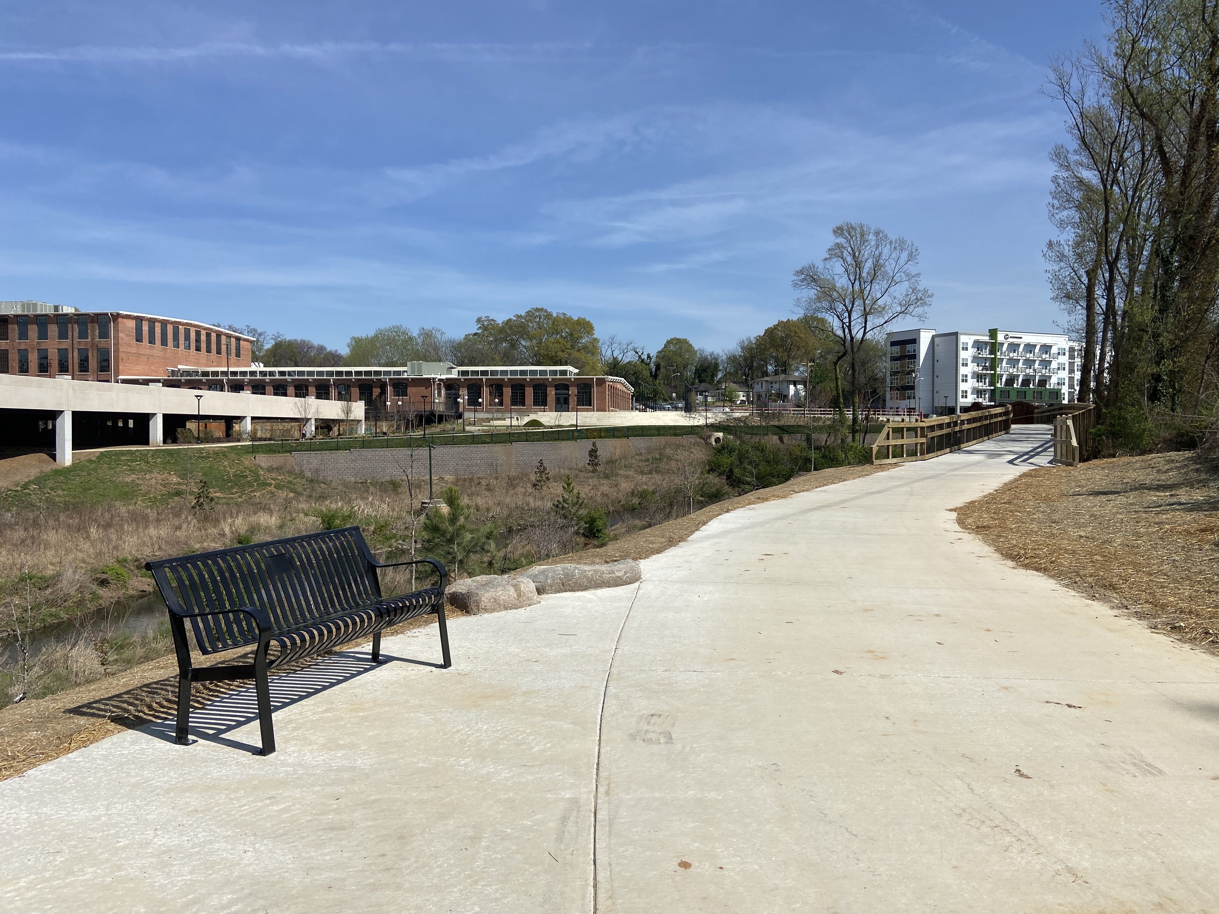 Stewart Creek Greenway. A bench is just before the boardwalk and bridge. 
