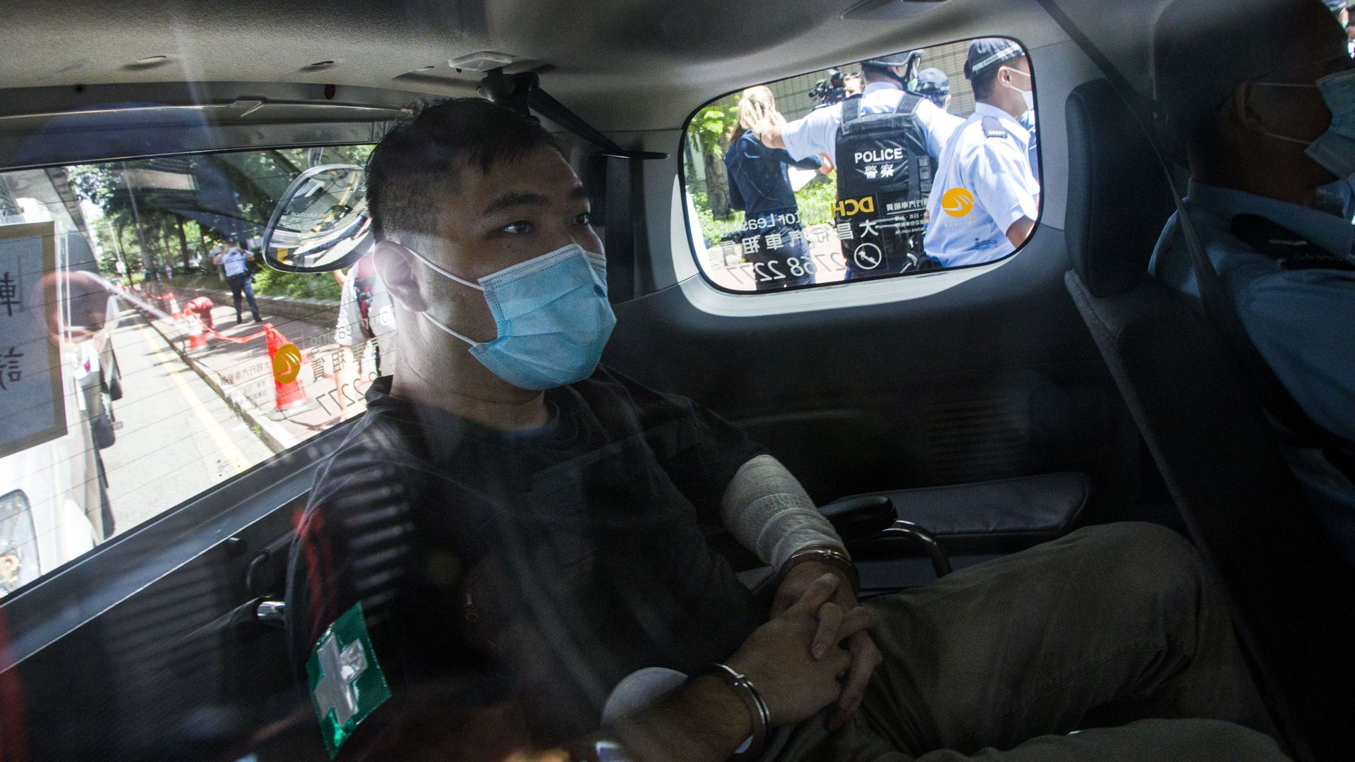 Hong Kong defendant Tong Ying-Kit, 23, arrives at court after being accused of deliberately driving his motorcycle into a group of police officers last Wednesday