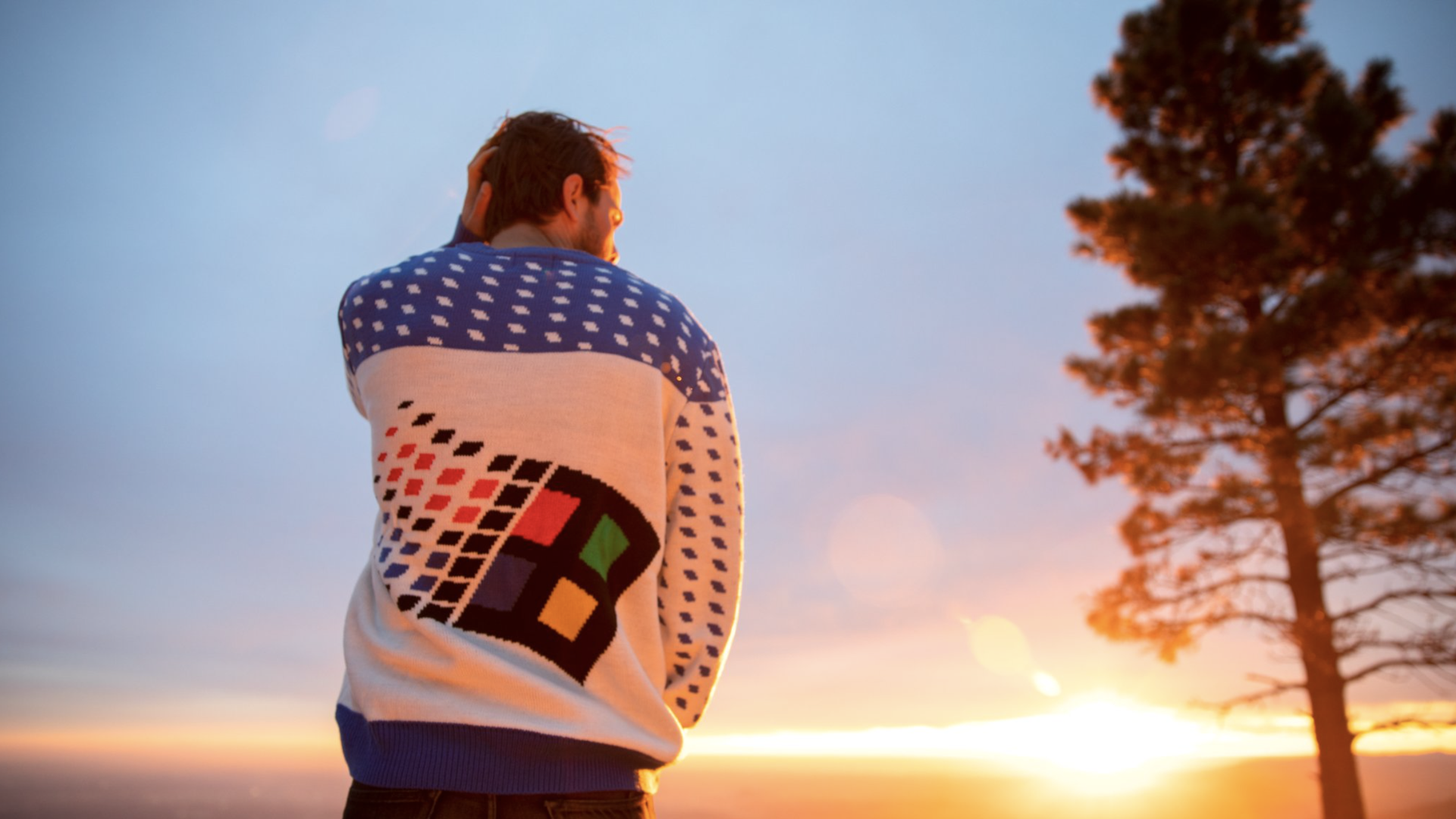 A model wearing a Windows 95 logo-ed ugly sweater