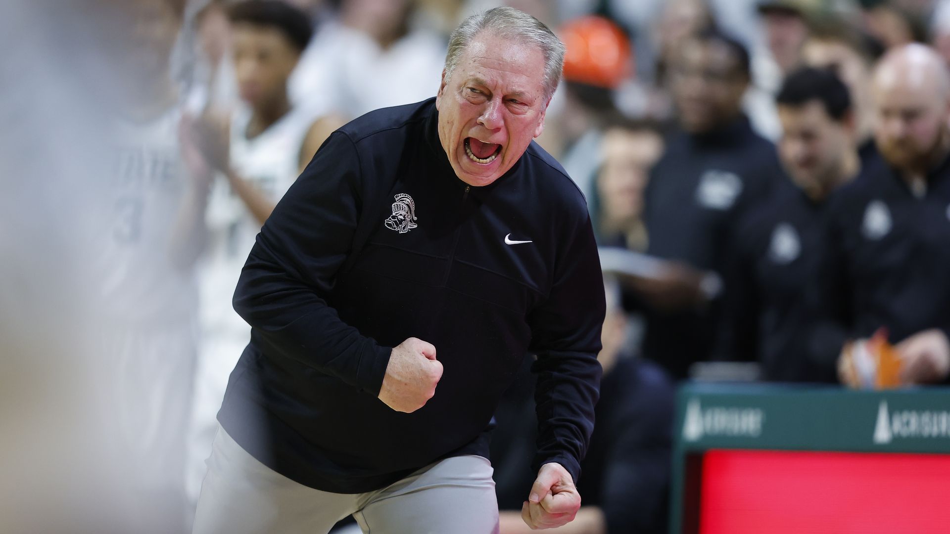 Michigan State coach Tom Izzo yells during a game with a clenched fist 