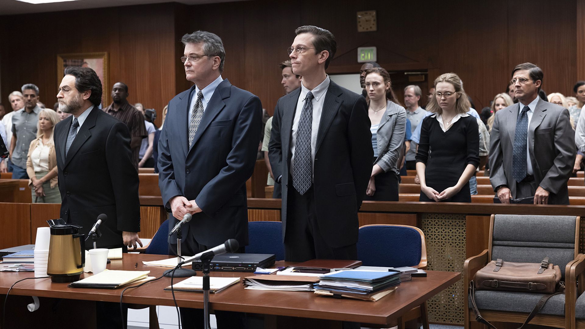 three men stand in a court during a tv show