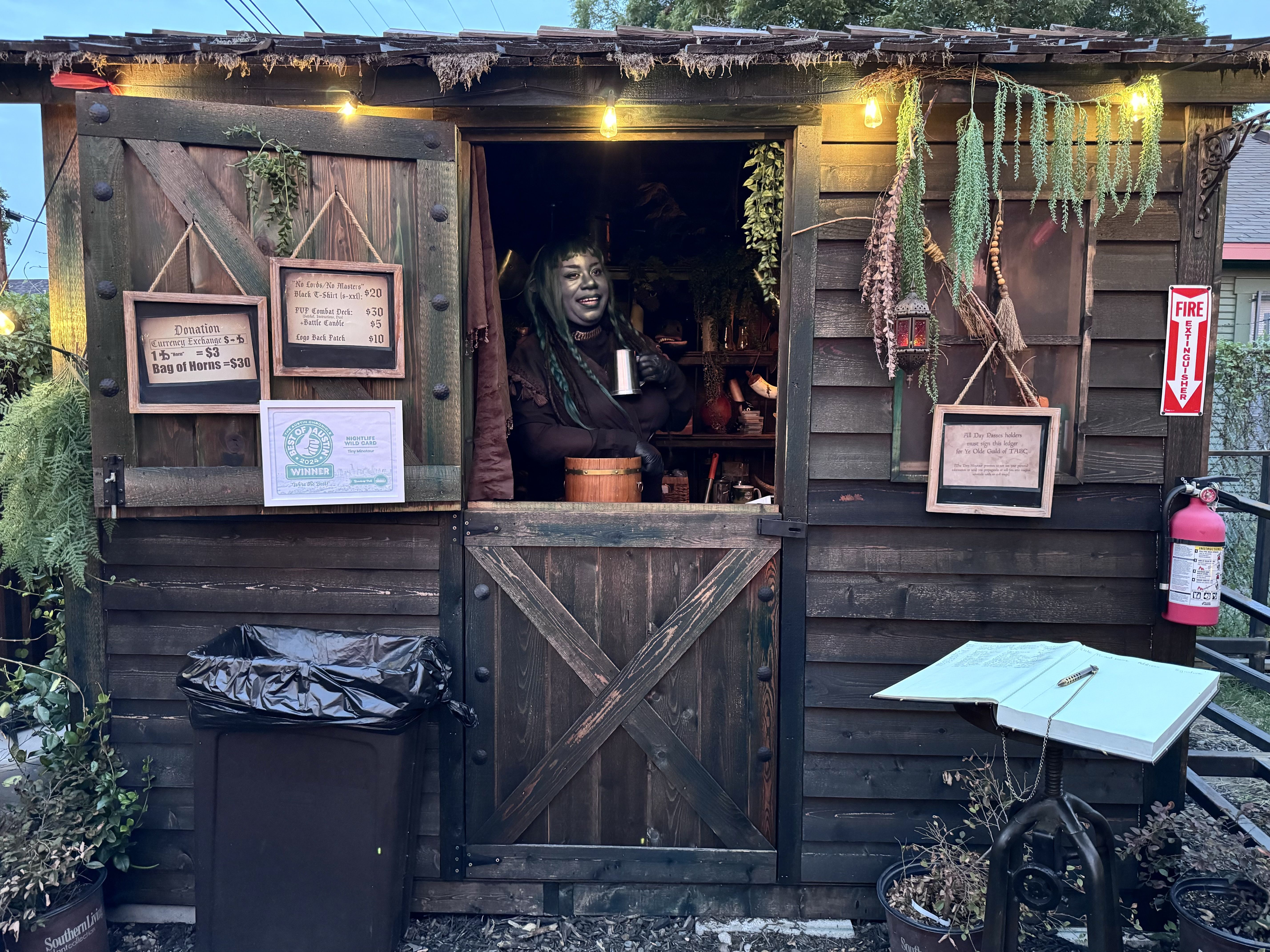 A photo of a person standing in a wooden shed.