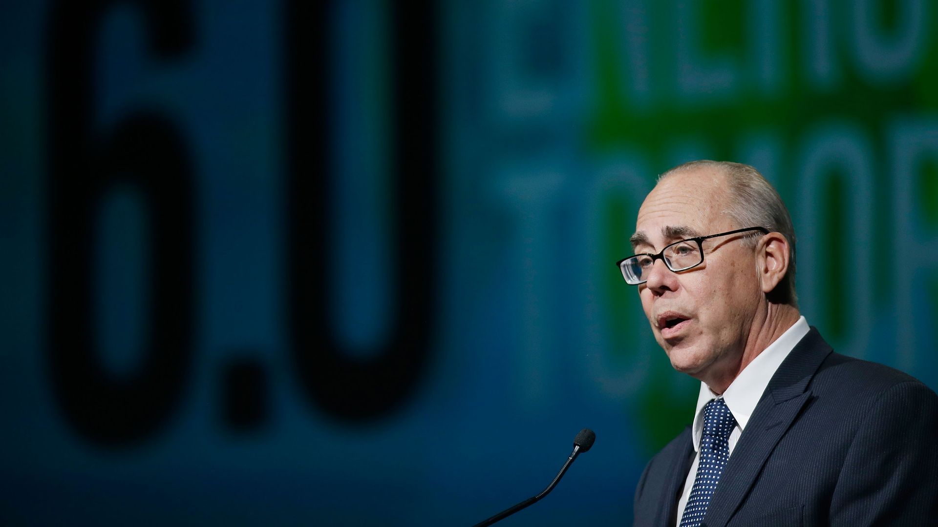 A man in glasses and a suit and tie