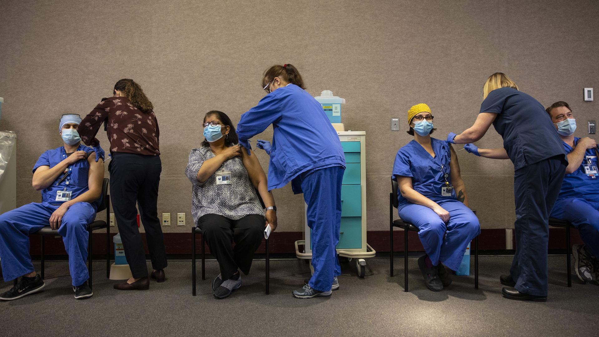 A photo of adults getting vaccinated.