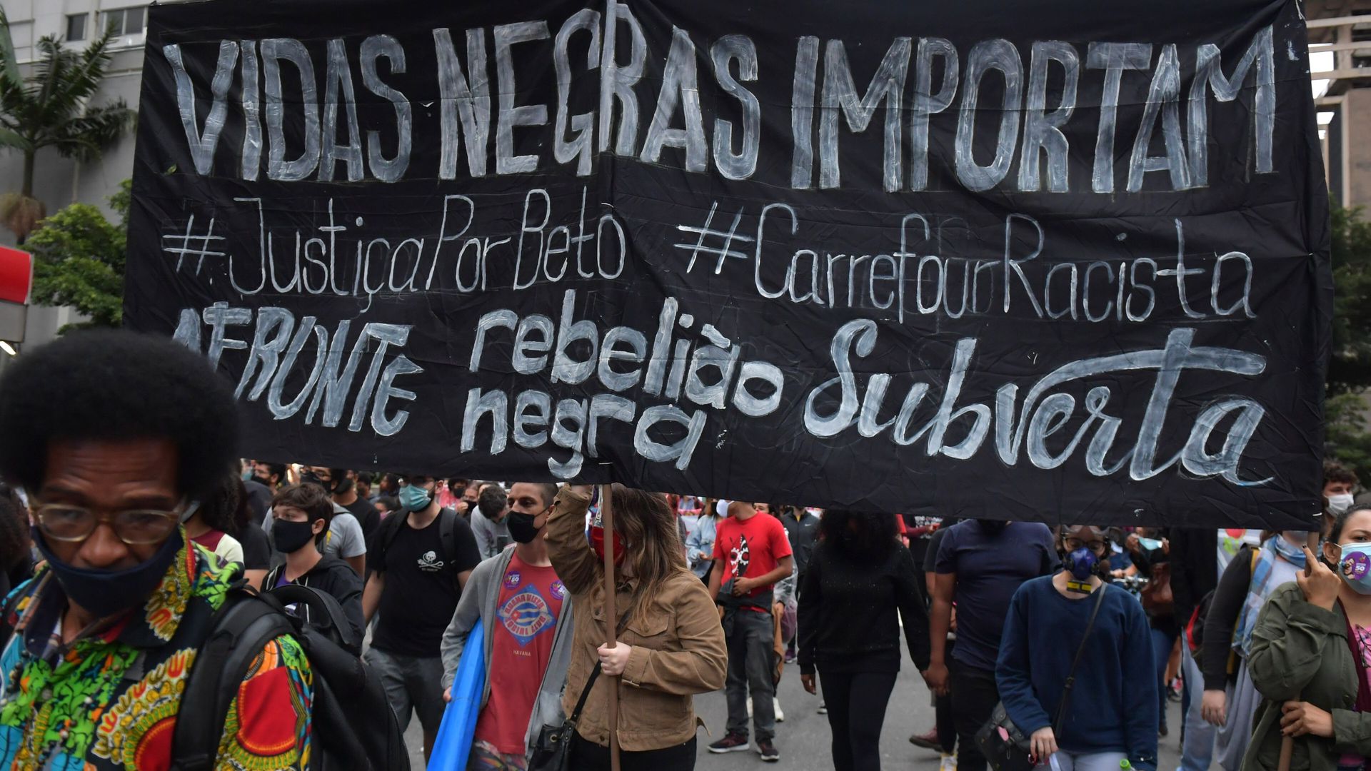 Protesters in Sao Paulo, Brazil, hold a banner that says "Black Lives Matter" in Portuguese.