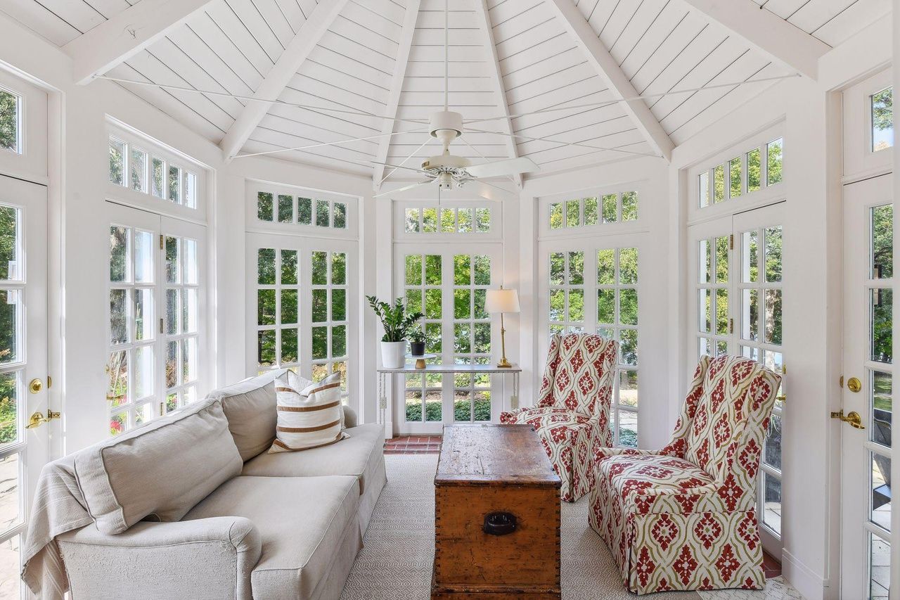 sunroom with window walls and white panels