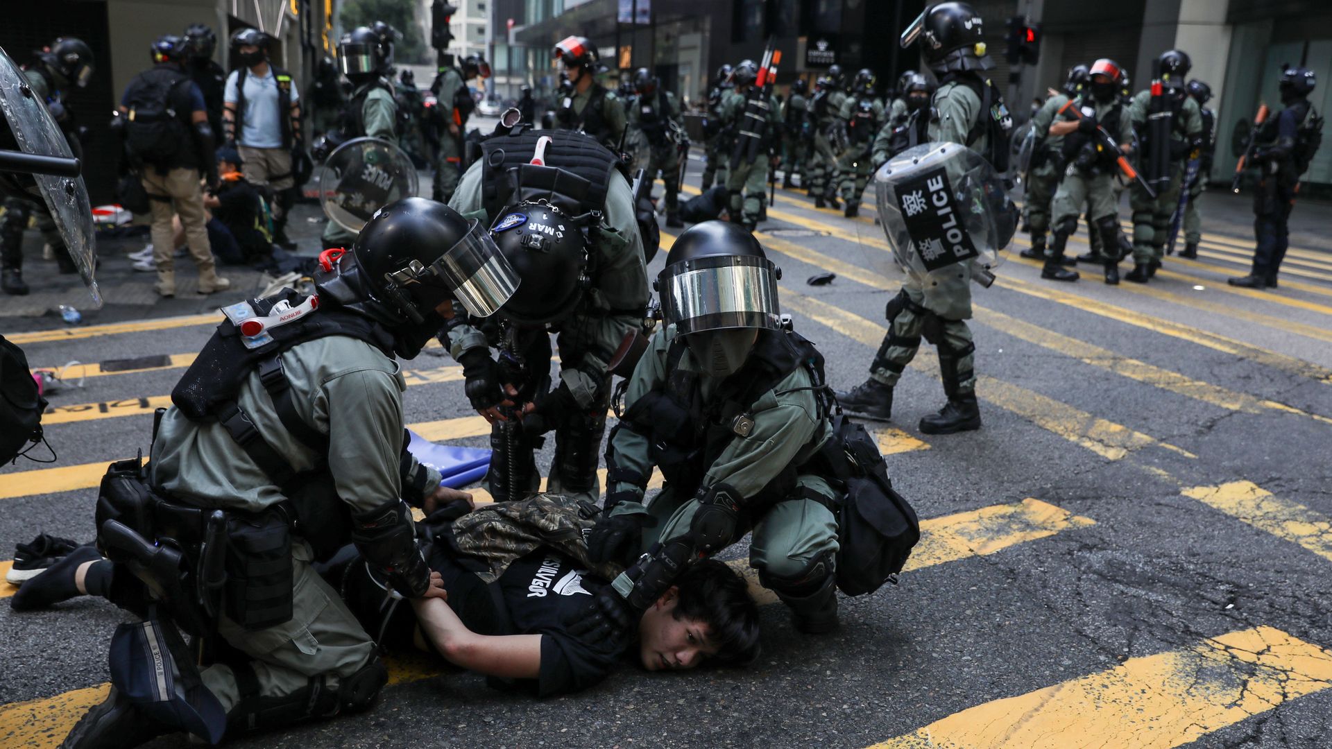 Police detain a man during a flash mob to block roads in the Central district in Hong Kong 