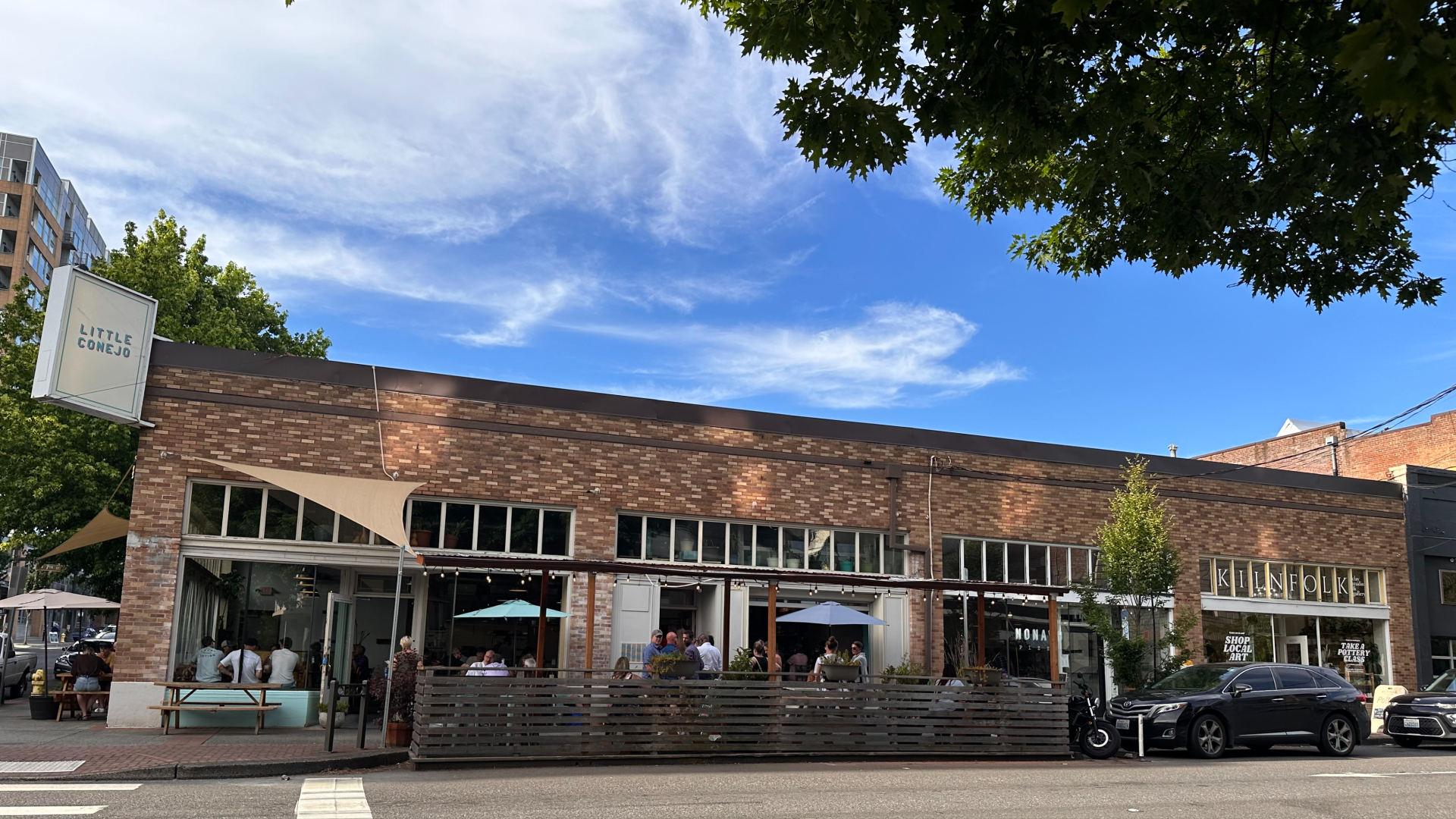 A photo of a building with a sign that reads "Little Conejo" 