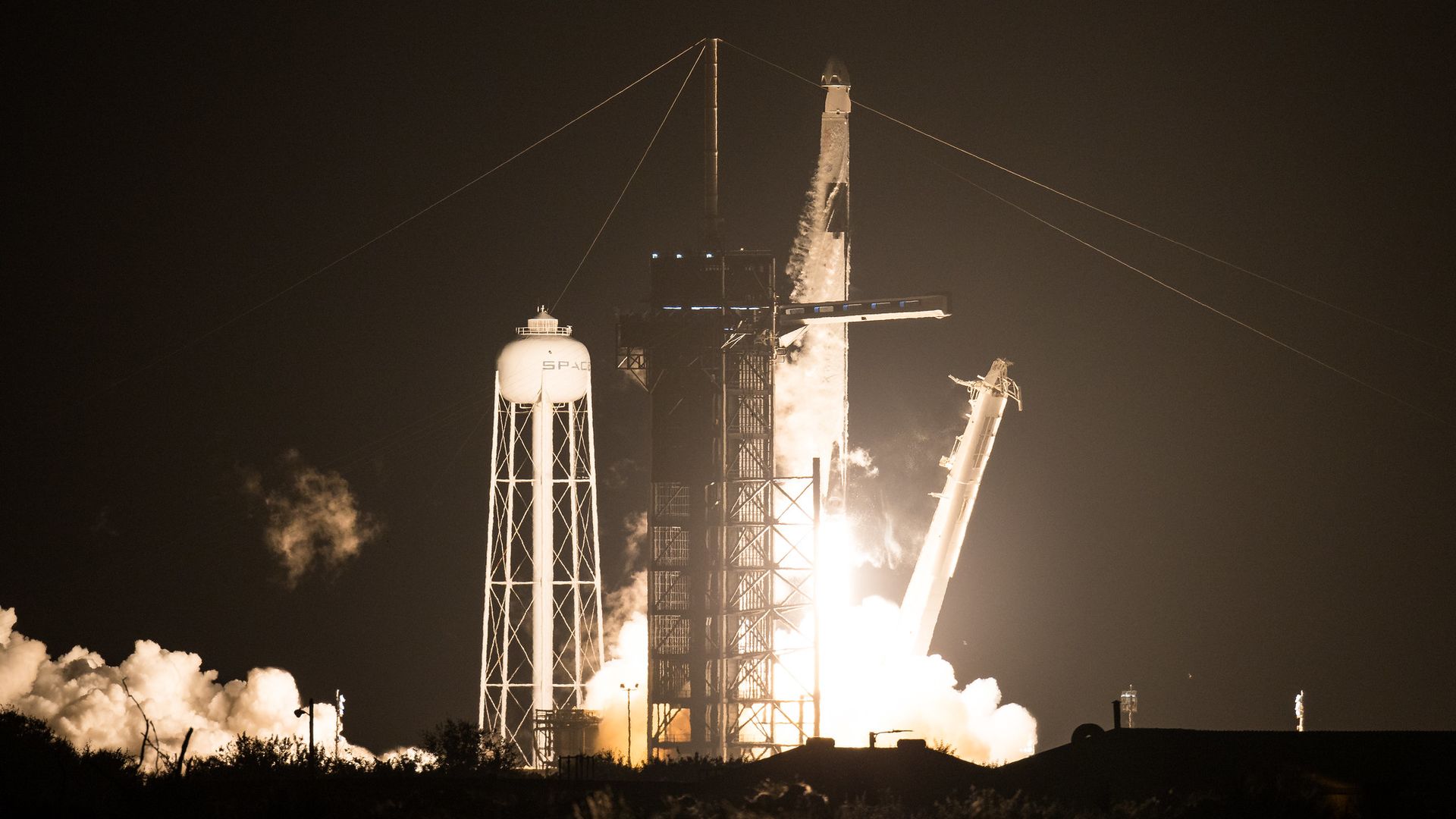 A SpaceX Falcon 9 rocket launching at night