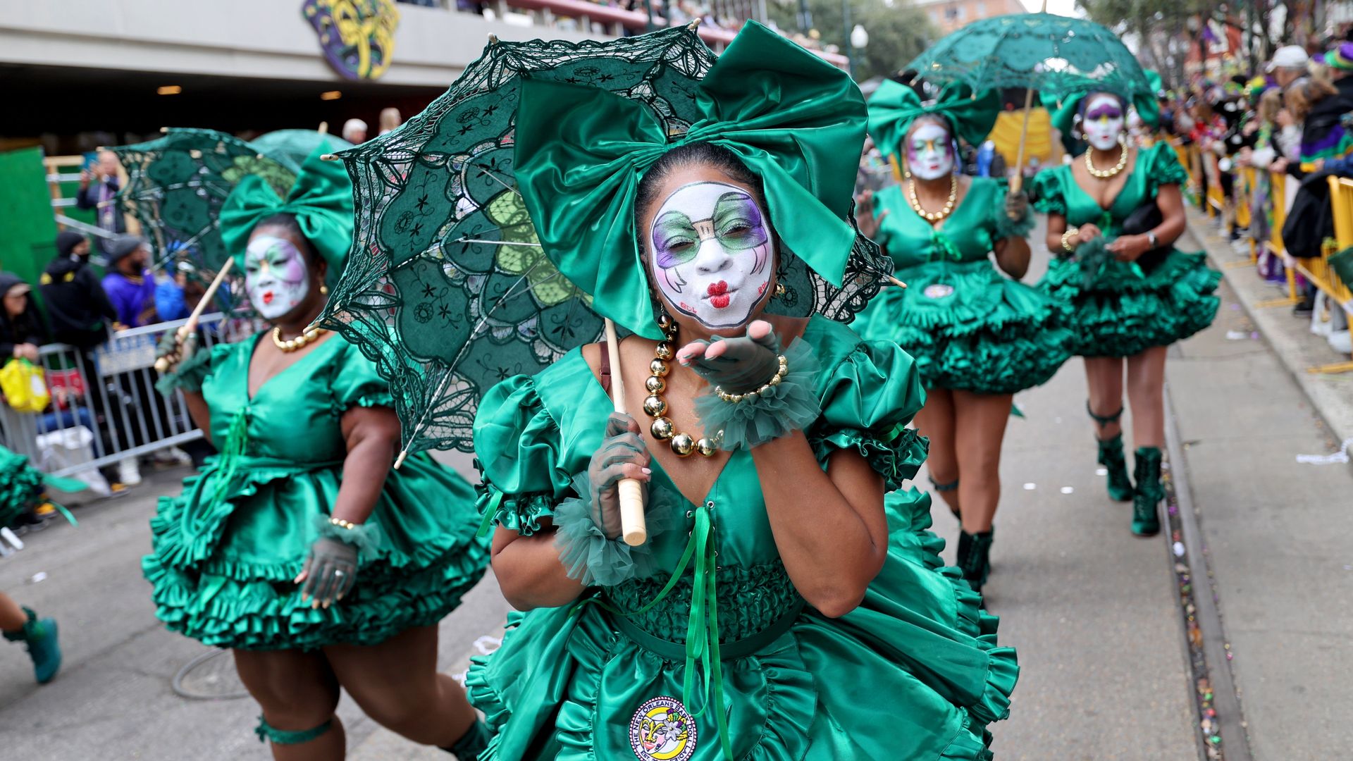Women dressed as Baby Dolls dance in a Mardi Gras parade.