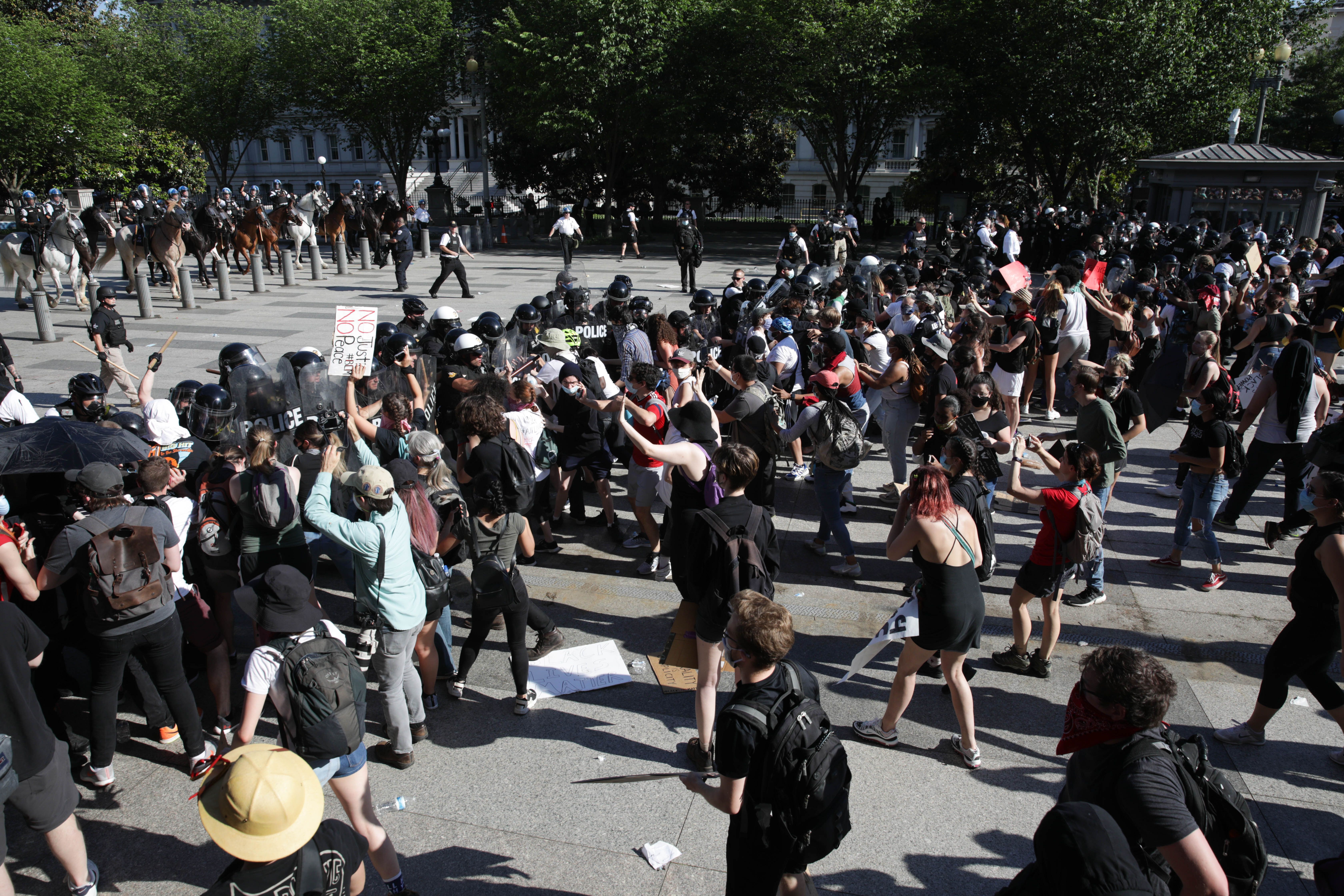 Demonstrators, gathered at Lafayette Park across from the White House, attempt to breach a police barricade during a protest over the death of George Floyd,