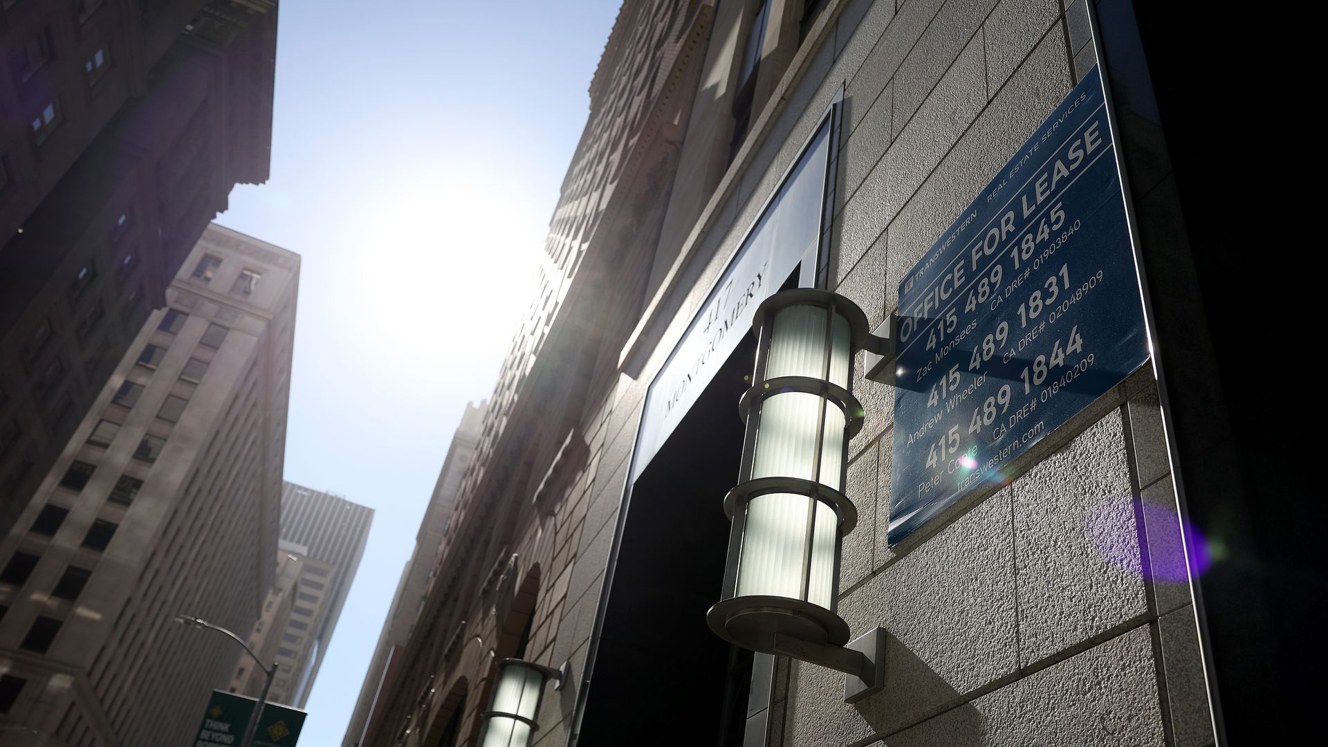 Photo of the exterior of a building with a sign that says "Office for lease"