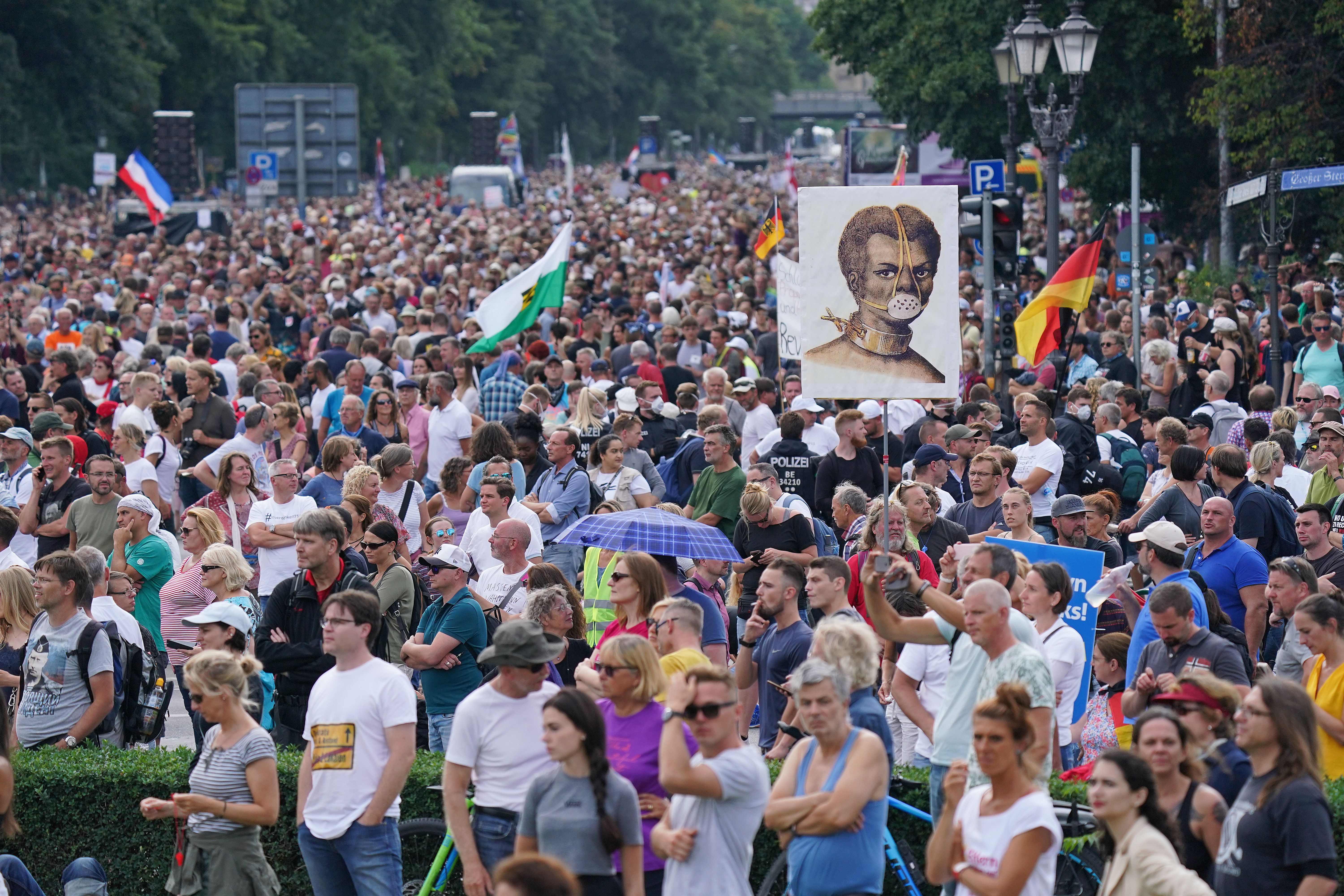 Protesters gather at the Victory Column in the city center to hear speeches during a protest against coronavirus-related restrictions and government policy on August 29, 2020 in Berlin, Germany. 