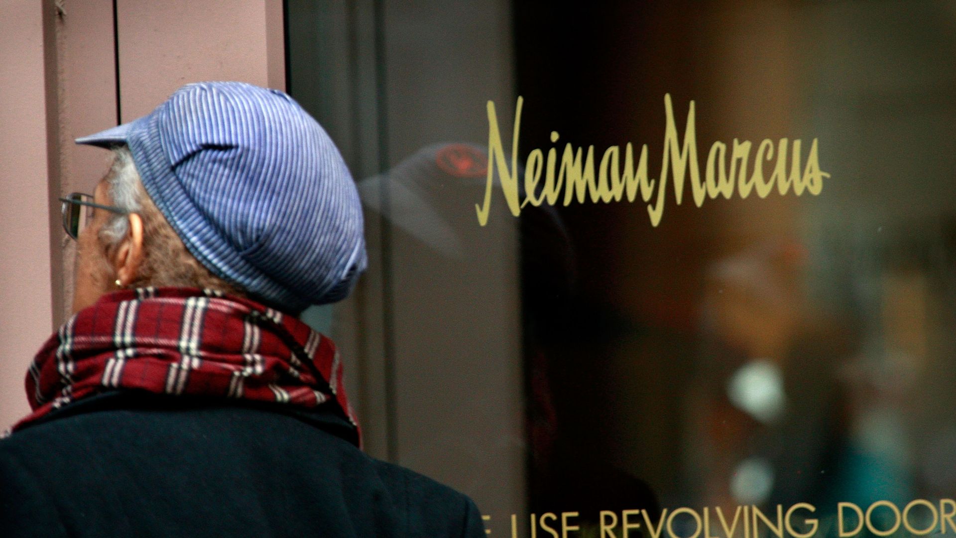 Photo shows a shopper entering a Neiman Marcus store