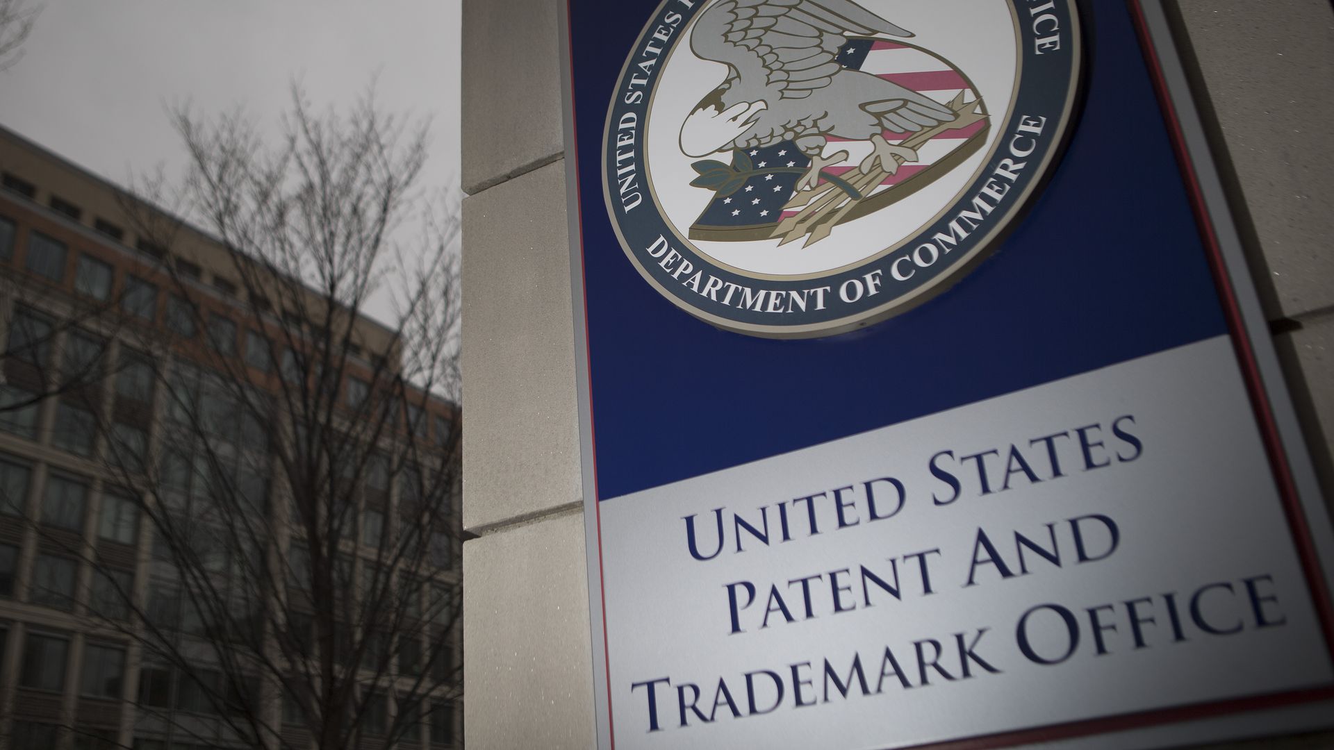 The U.S. Patent and Trademark Office (USPTO) seal is displayed outside the headquarters in Alexandria, Virginia, U.S., on Friday, April 4, 2014. 
