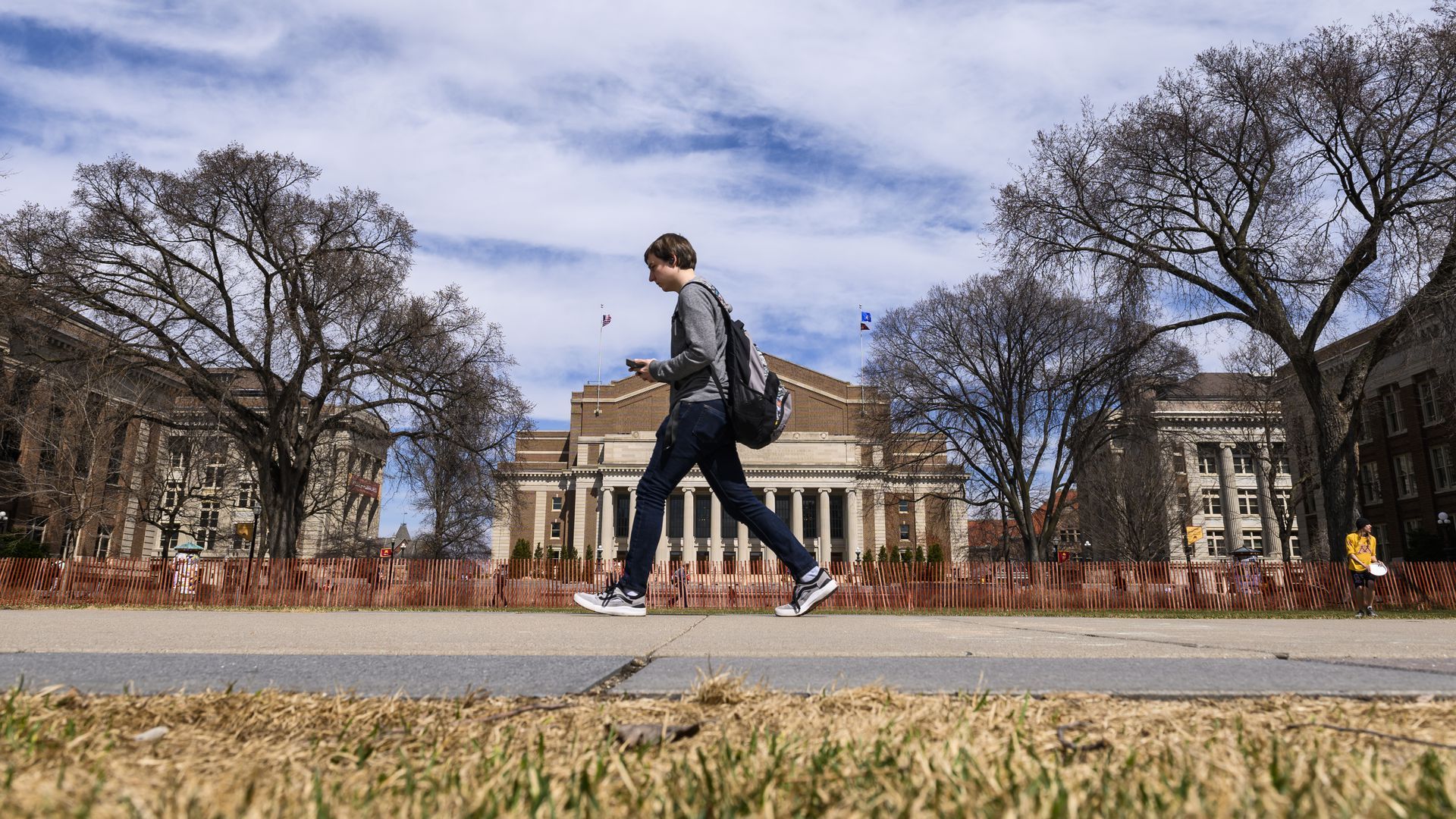 A student walks across campus
