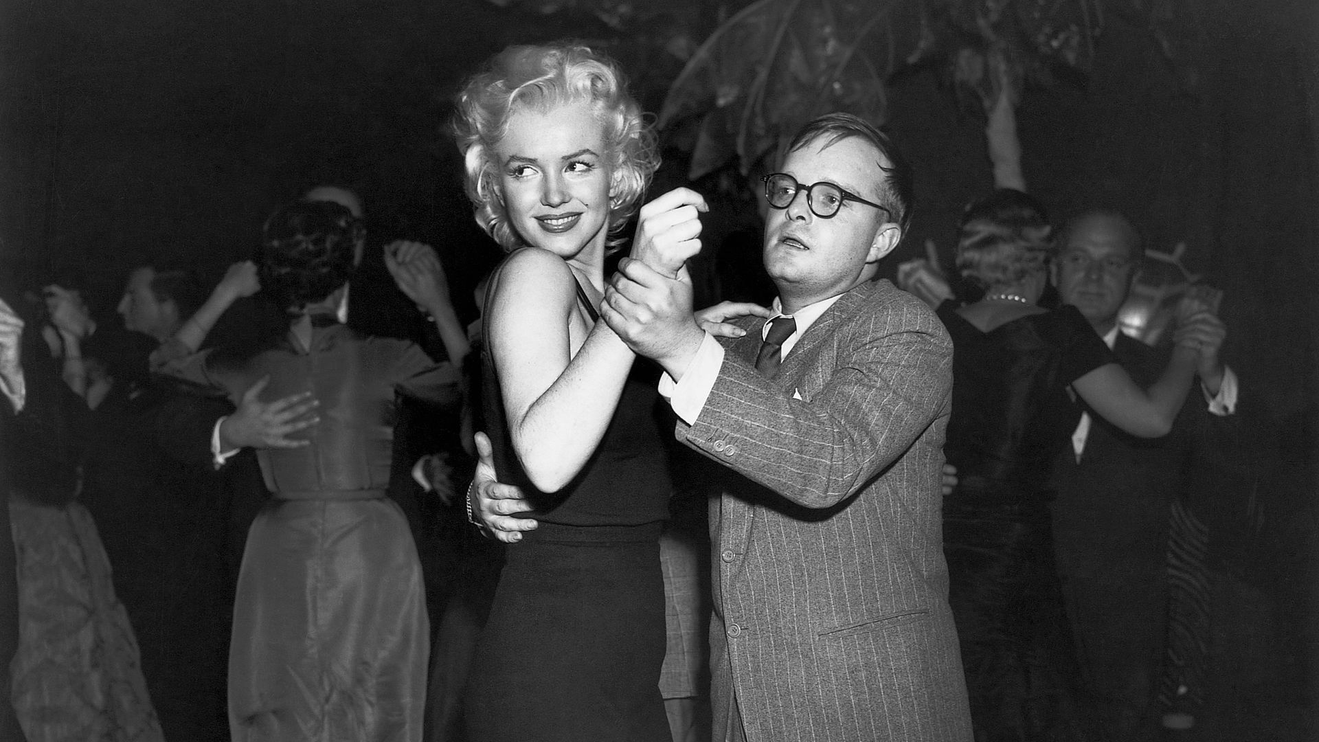 Photo shows Truman Capote dancing with Marilyn Monroe.