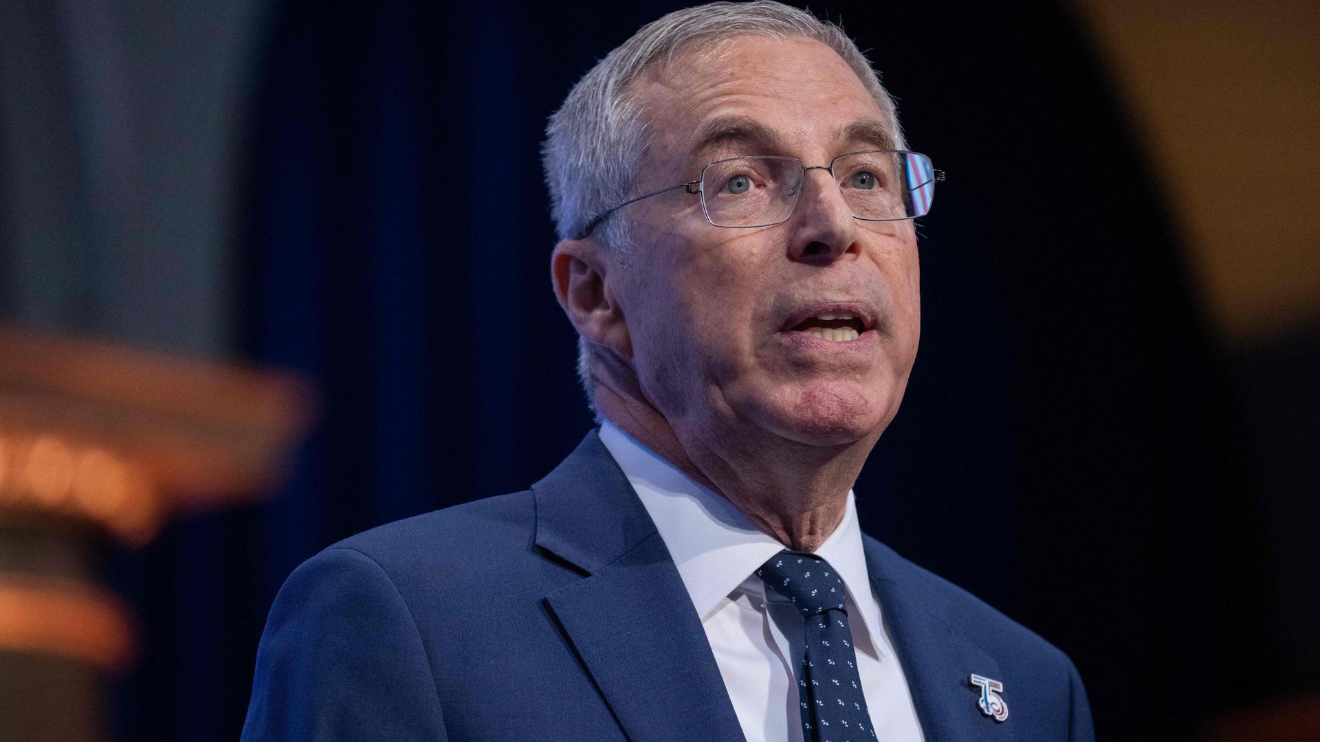 Israeli Ambassador to the U.S. Michael Herzog, wearing a blue suit, light blue shirt, blue tie and glasses.
