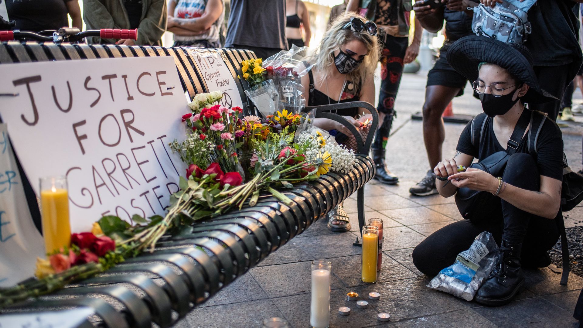 An attendee lights a candle at a vigil for Garrett Foster on July 26, 2020 in downtown Austin, Texas