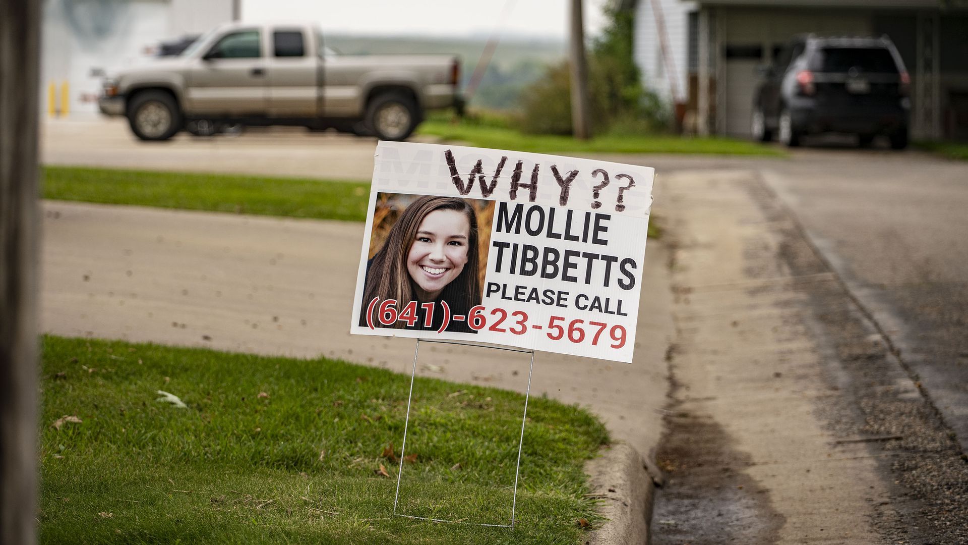 A lawn sign asking people to call a phone number with information about Mollie Tibbetts.