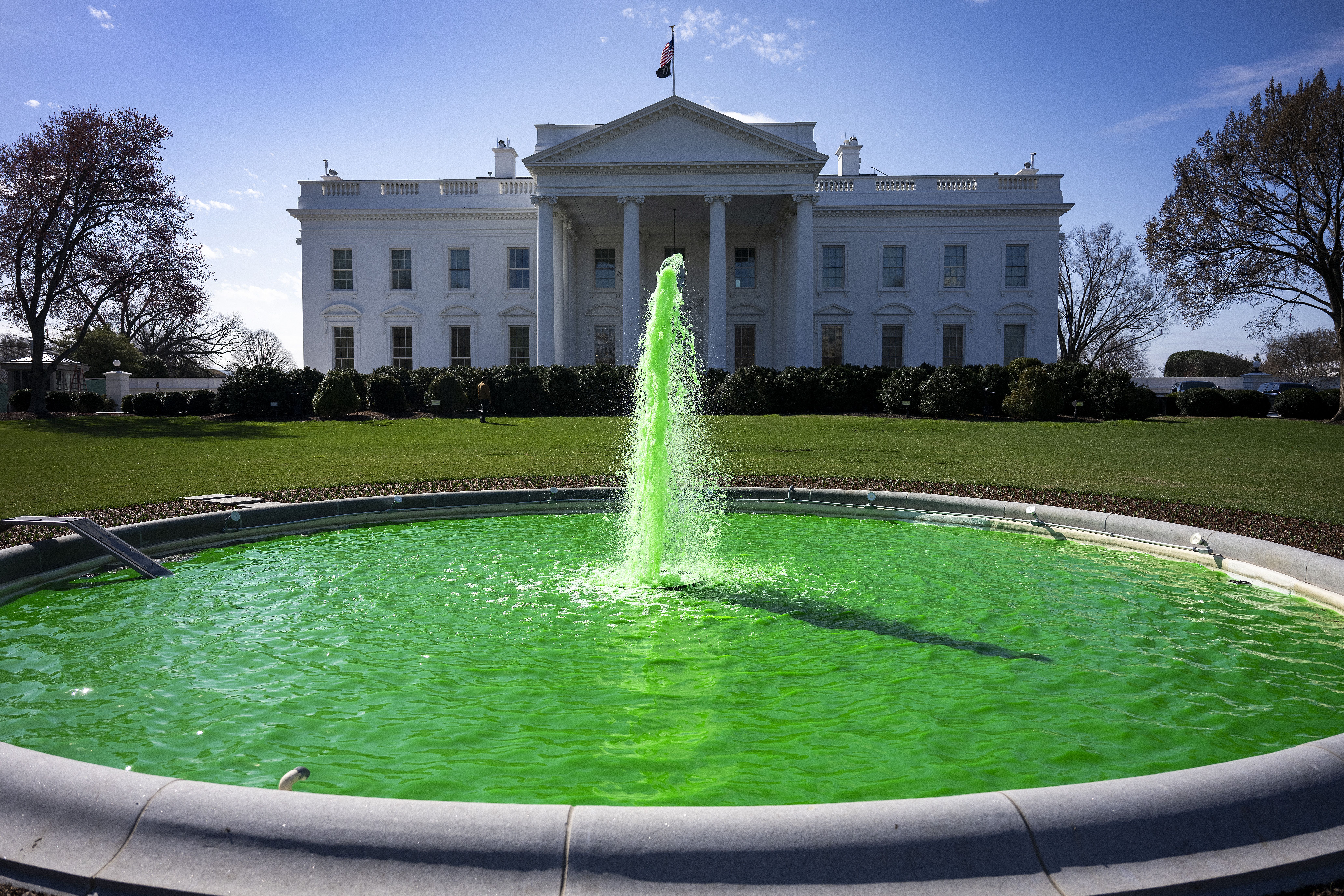 TOPSHOT - The fountain on the North Lawn of the White House is dyed green for St. Patrick's Day in Washington, DC, on March 17, 2025. (Photo by Jim WATSON / AFP) (Photo by JIM WATSON/AFP via Getty Images)