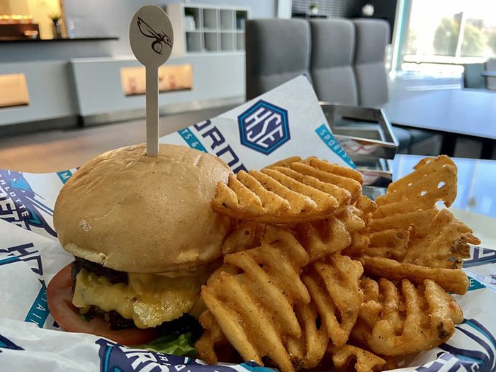 Pavilion burger and waffle fries. Photo: Ashley Mahoney/Axios 