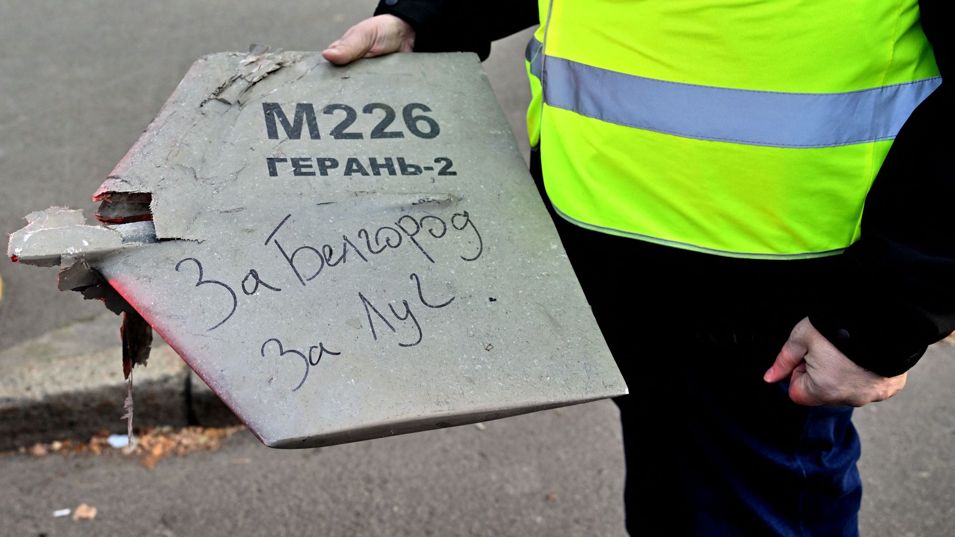 A police officer in Kyiv holding a fragment of an Iranian-made "kamikaze" drone fire on the city by Russia in October 2022. 