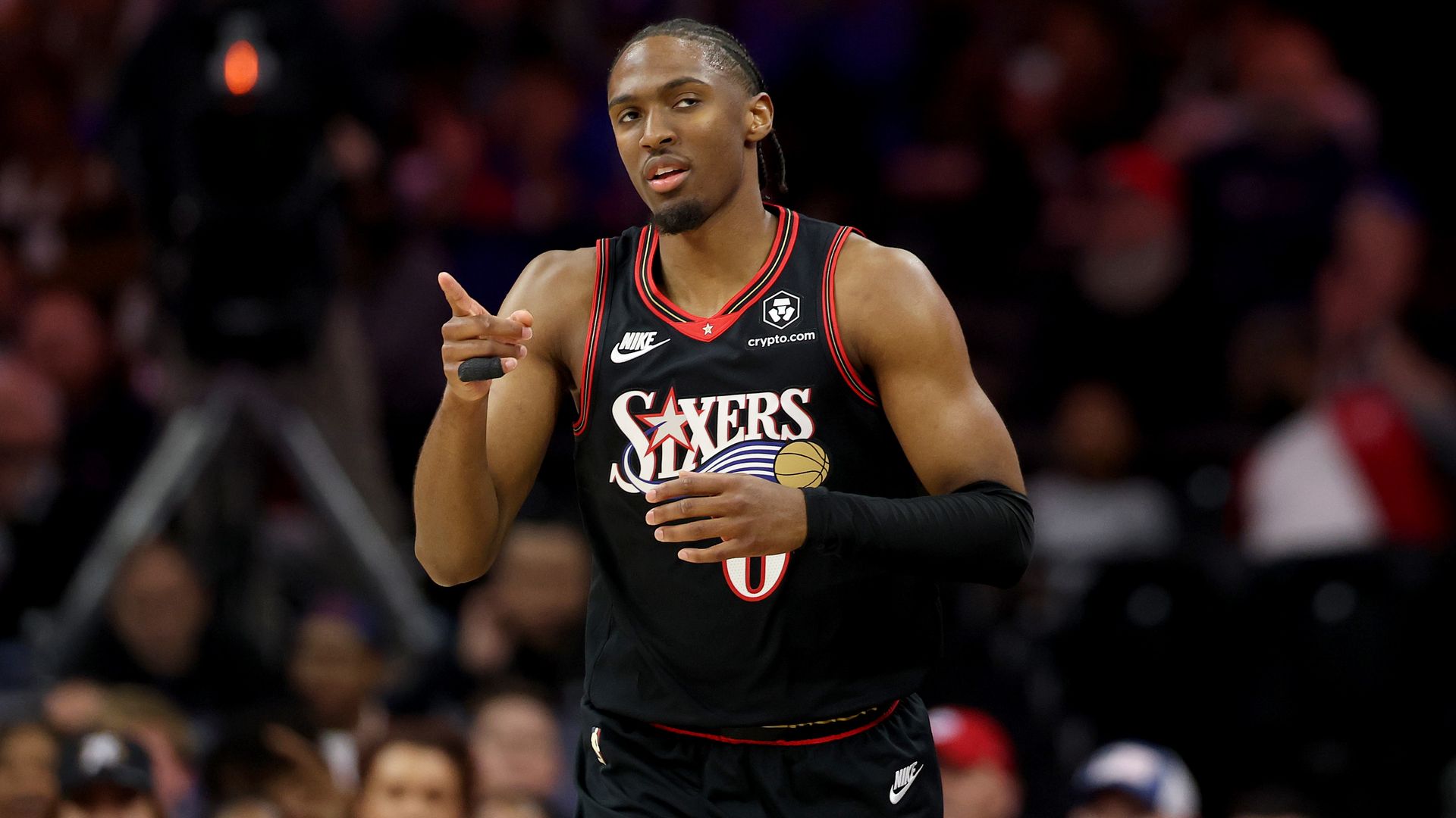 Sixers guard Tyrese Maxey celebrates a three-pointer with a fan during the second half against the Milwaukee Bucks.
