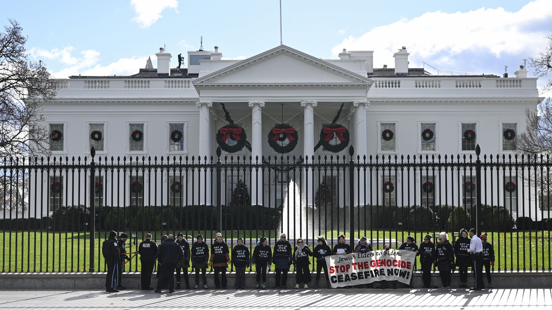 Pro-Palestine protestors chain themselves to the White House fence before the annual Hanukkah party. 