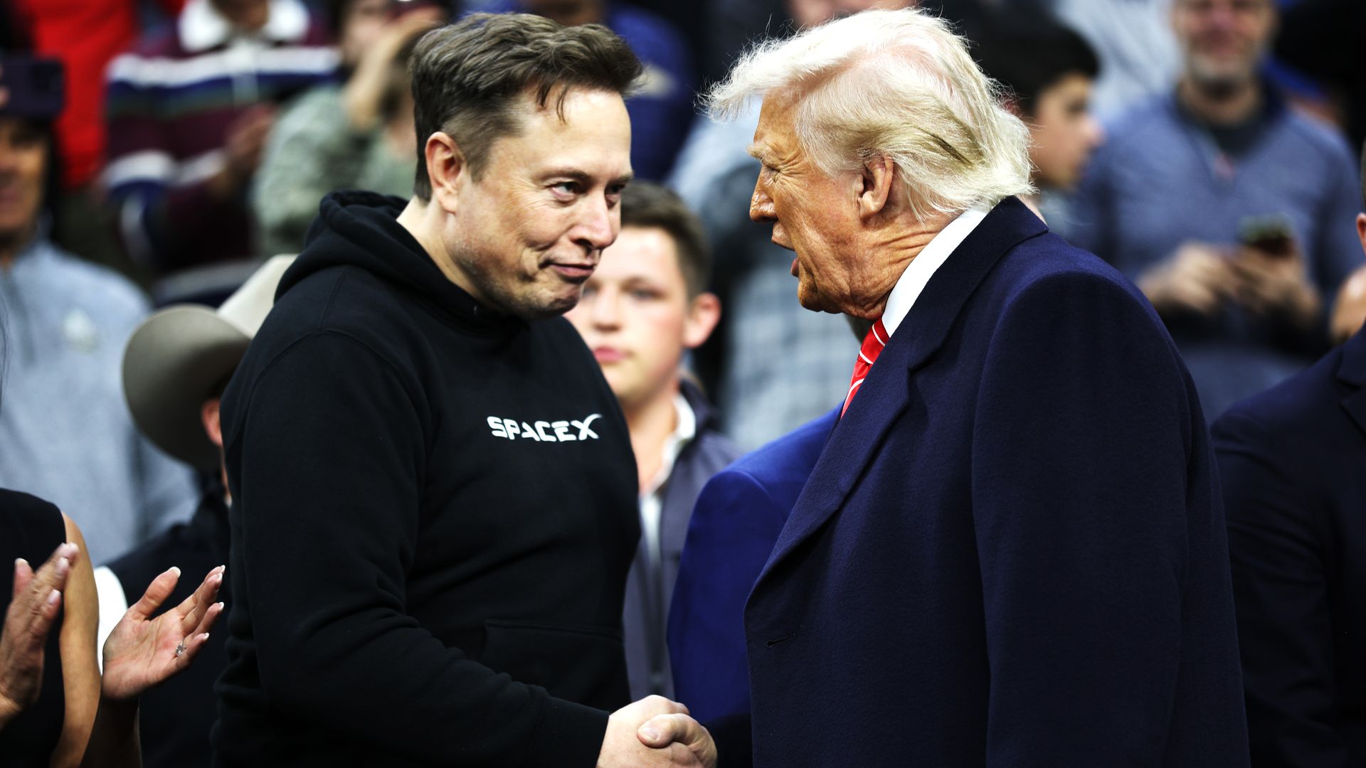 Elon Musk and Donald Trump shaking hands