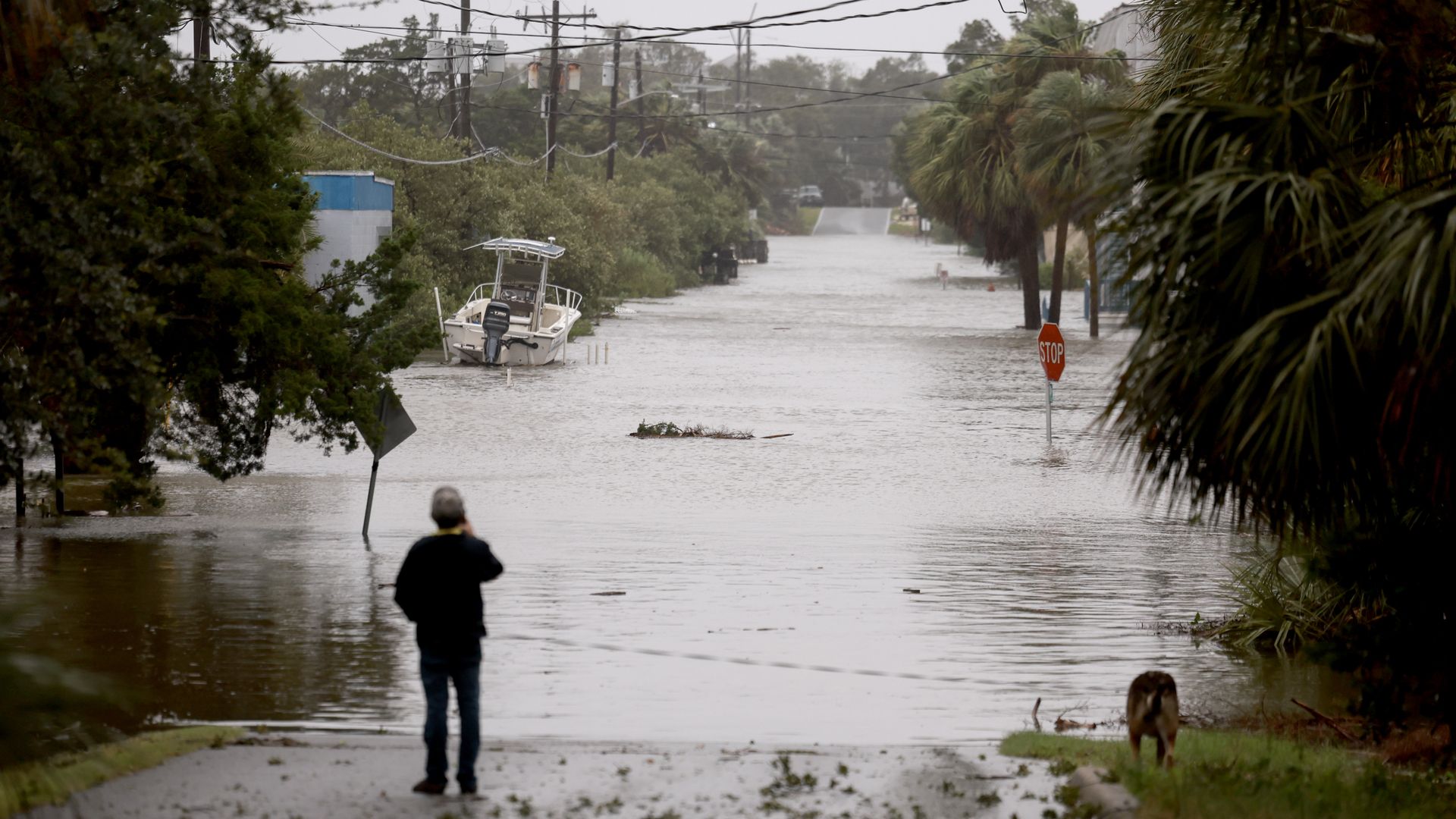 A person surveys a flooded street in Florida after Hurricane Debby made landfall on Monday, Aug. 5.
