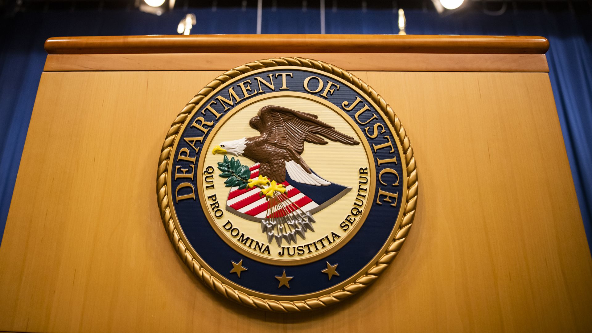 The Department of Justice seal on a podium.