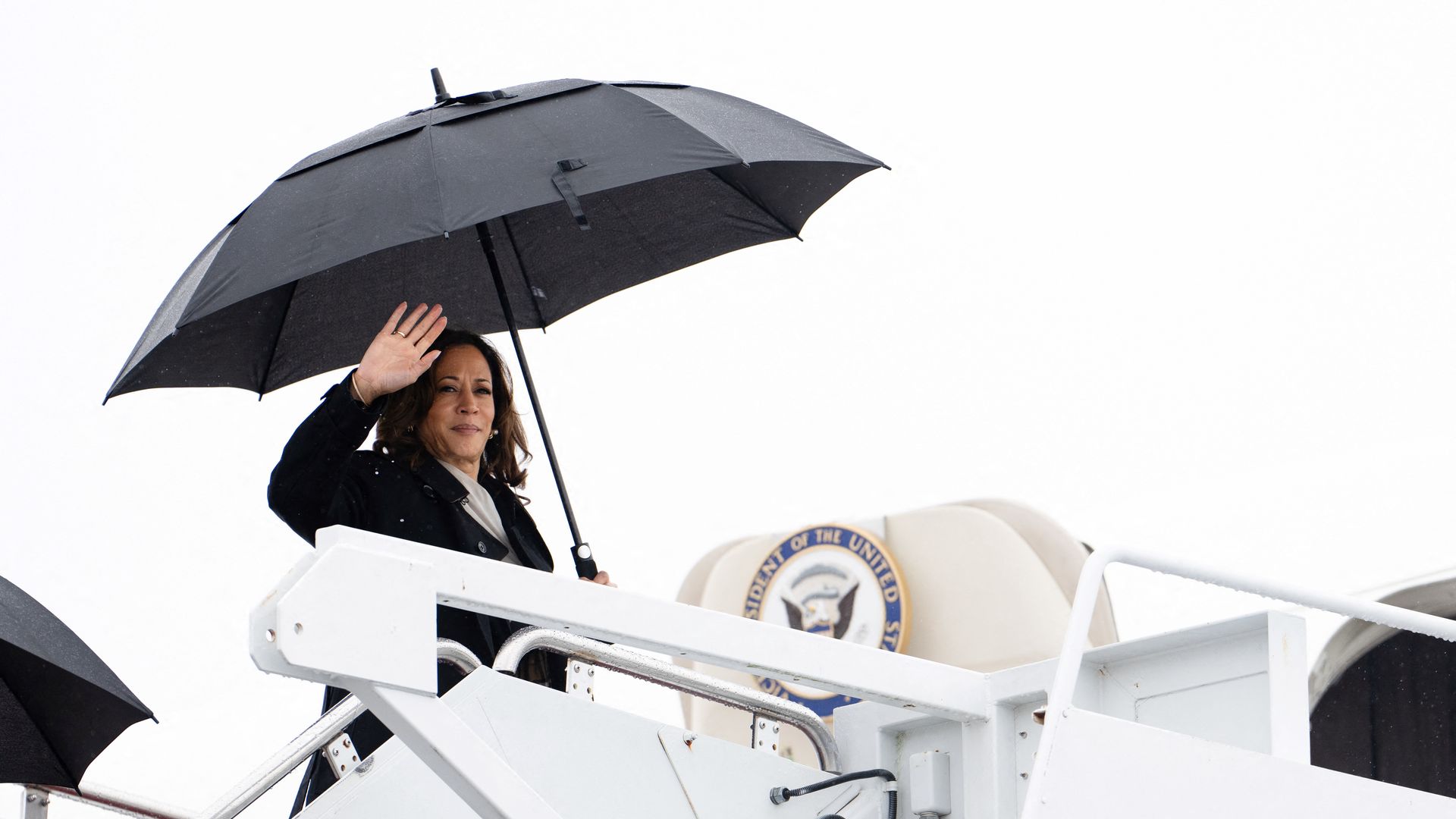 Kamala Harris holding an umbrella