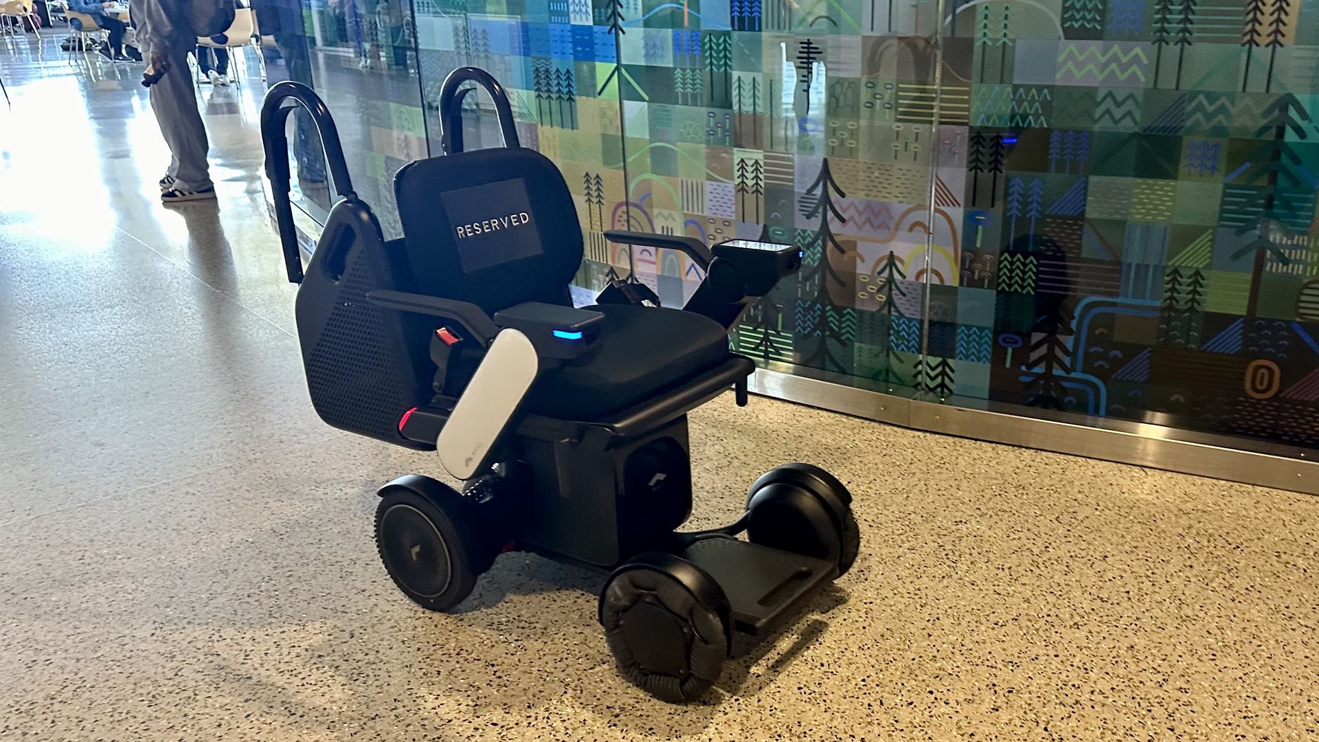 A photo of an empty robot wheelchair at Seattle-Tacoma International Airport. 