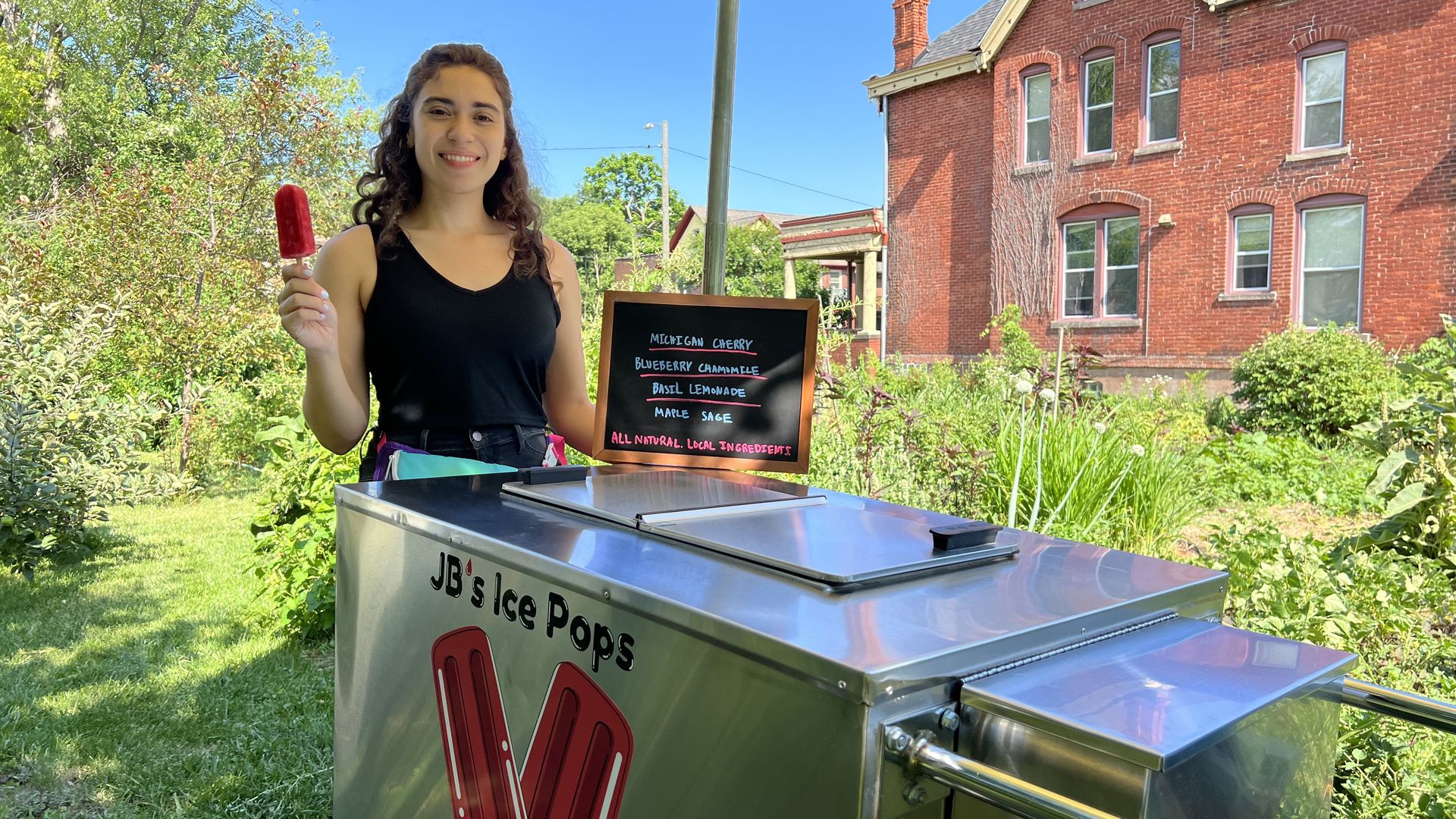 Jena Brooker of JB's Ice Pops in front of her cart.