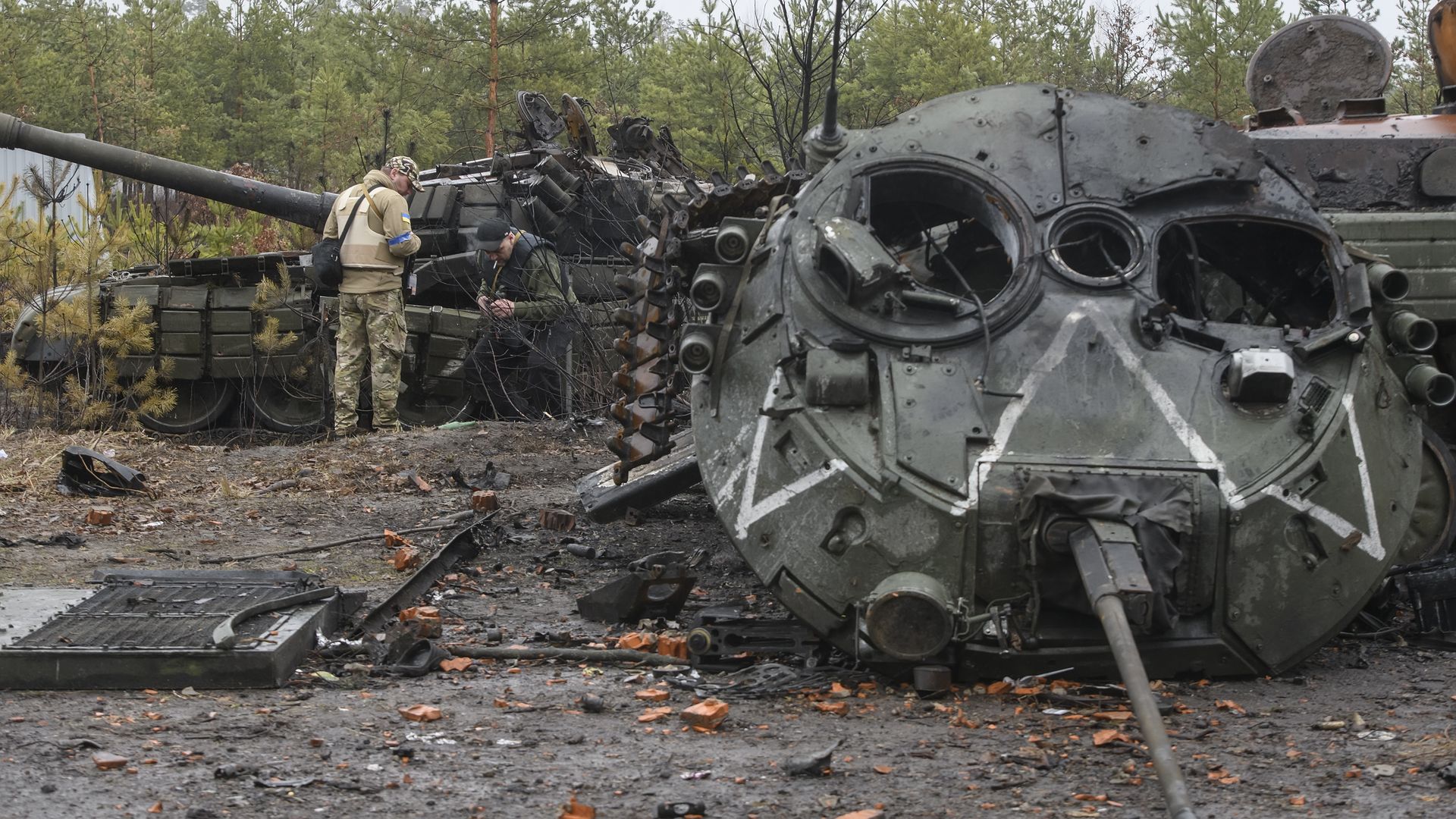 Ukrainian servicemen check destroyed Russian tanks and armored machines after Ukrainian Army liberation Dmitrovka village near Kyiv, Ukraine, April 02.