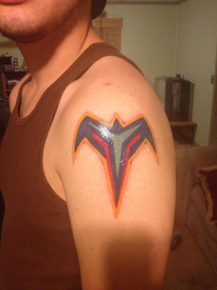 A tattoo of the logo of the Atlanta Thrashers, a defunct hockey team, on a person's shoulder