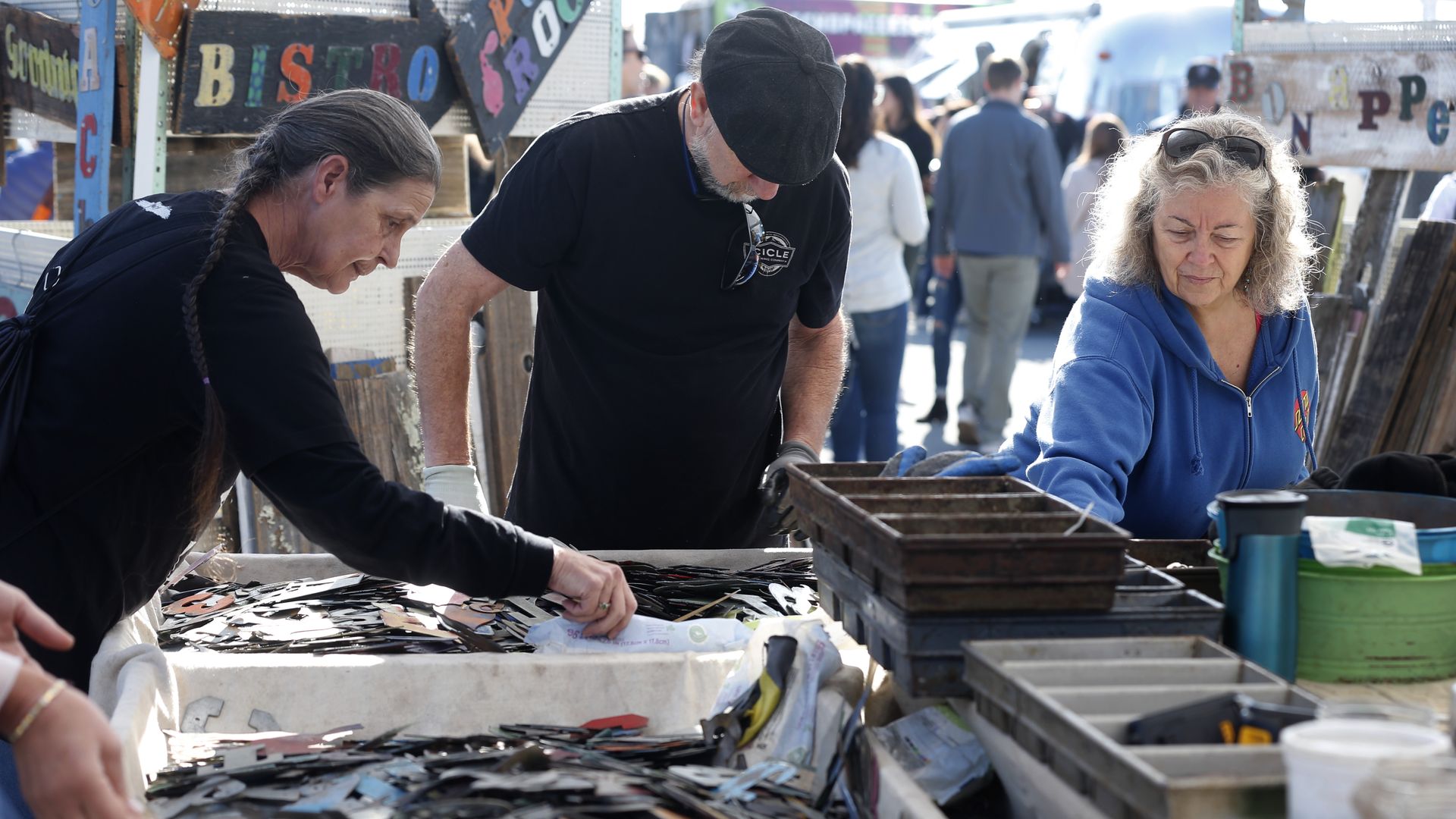 people browsing goods on a stand