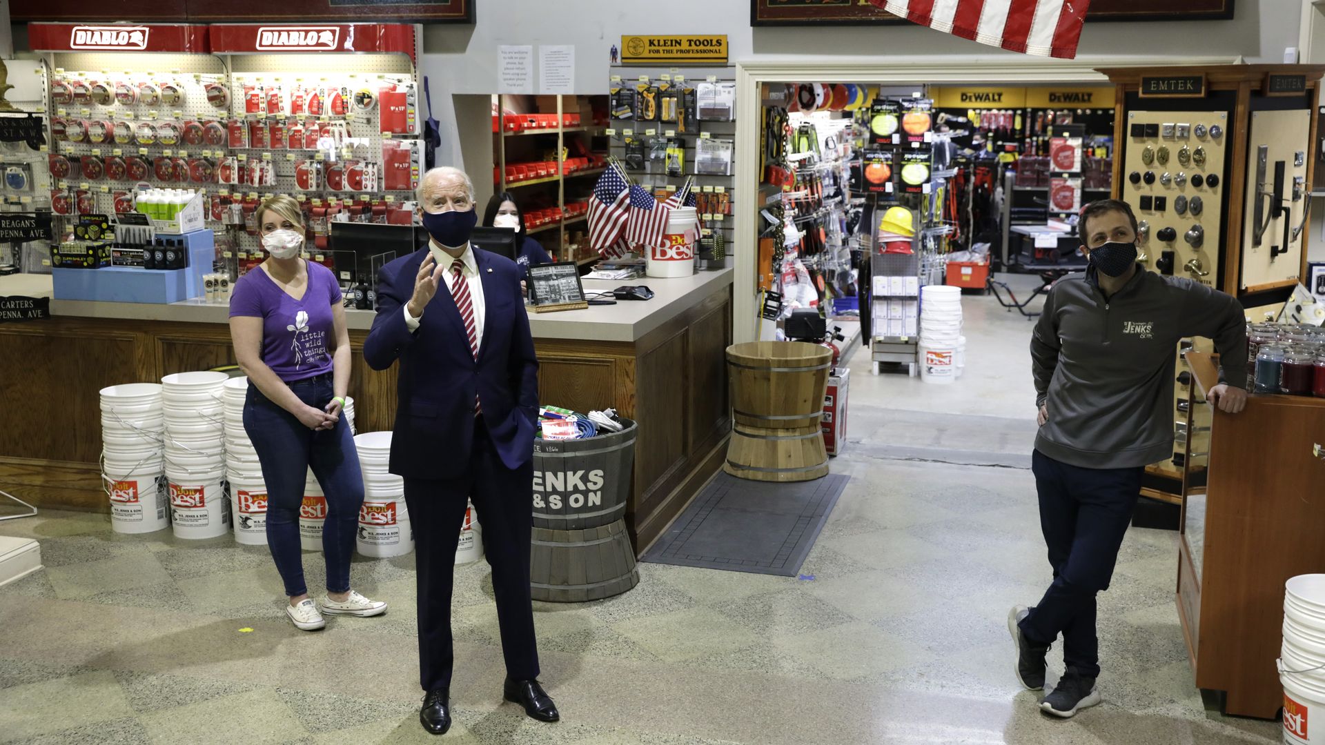 President Biden is seen speaking to workers as he visits a hardware store in Washington to discuss his COVID-19 relief package.