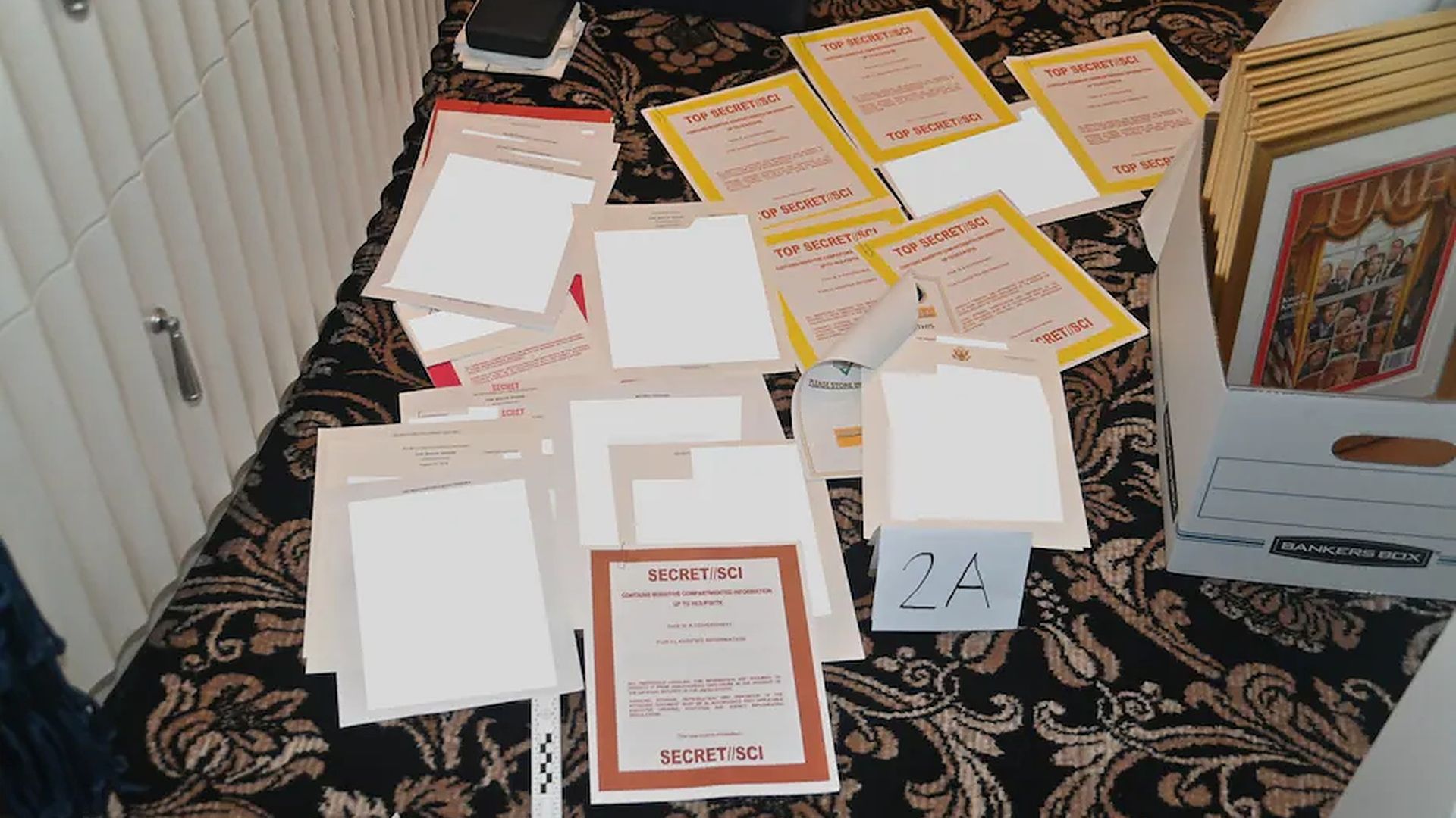 An image provided by the Department of Justice showing partially redacted documents with classified markings.