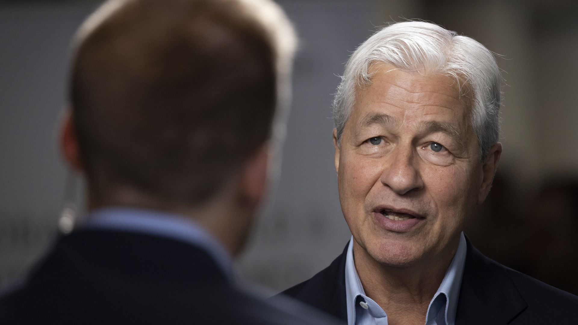 picture of a man with white hair being interviewed on television