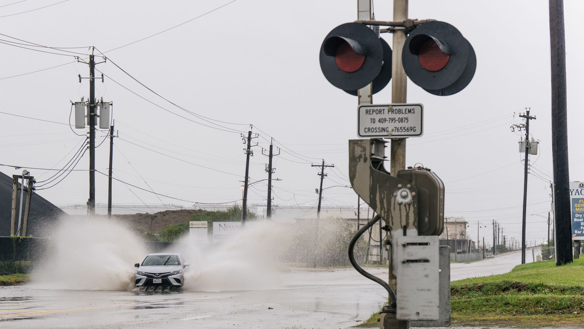  A car speeds through a flooded street ahead of the Tropical Storm Nicholas on September 13, 2021 in Galveston, Texas. 