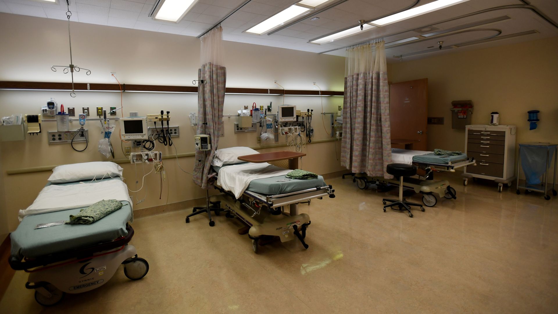 Vacant hospital beds in an emergency room.