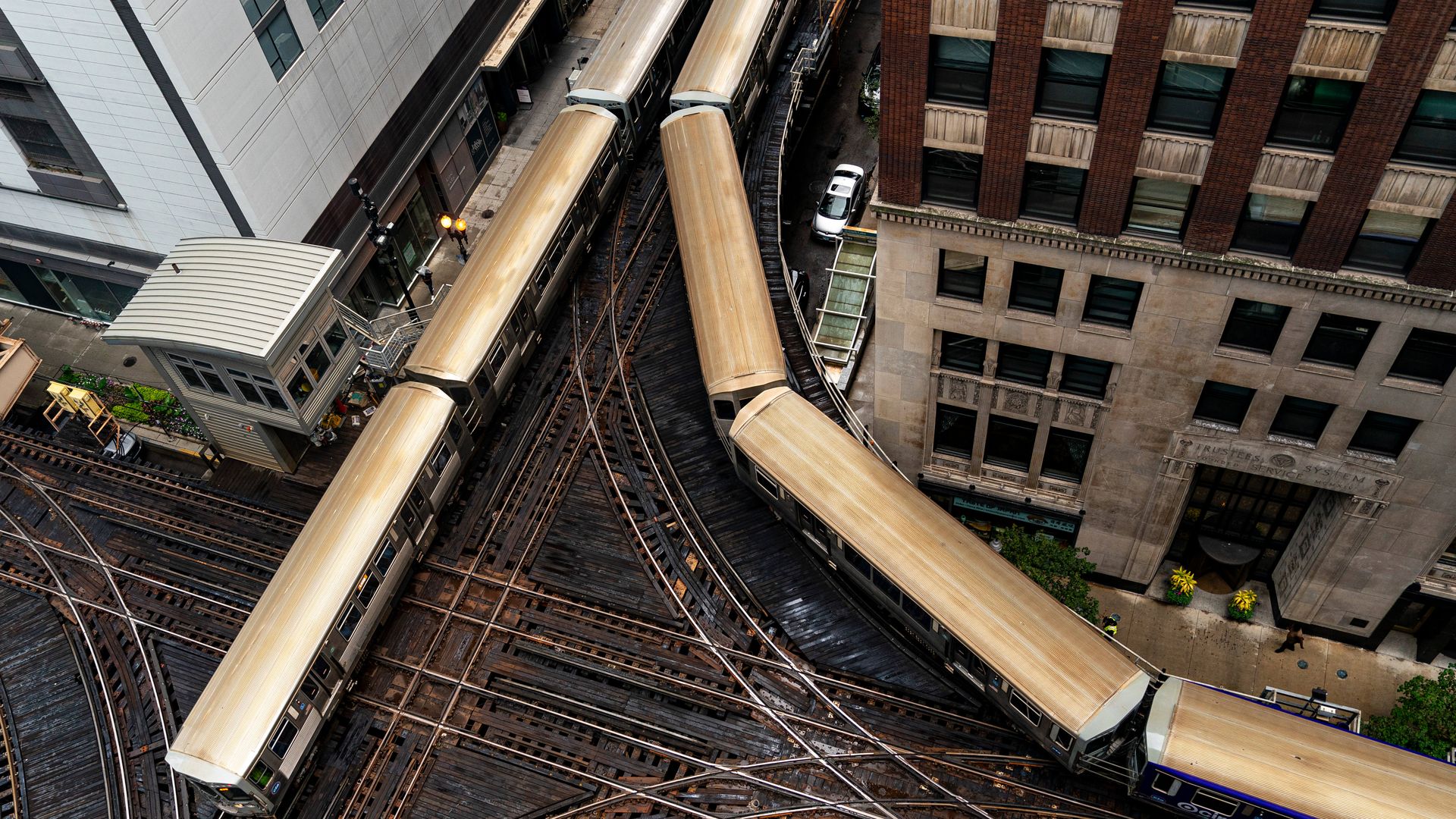 Aerial view of intersecting train trackers with trains on them in Chicago.