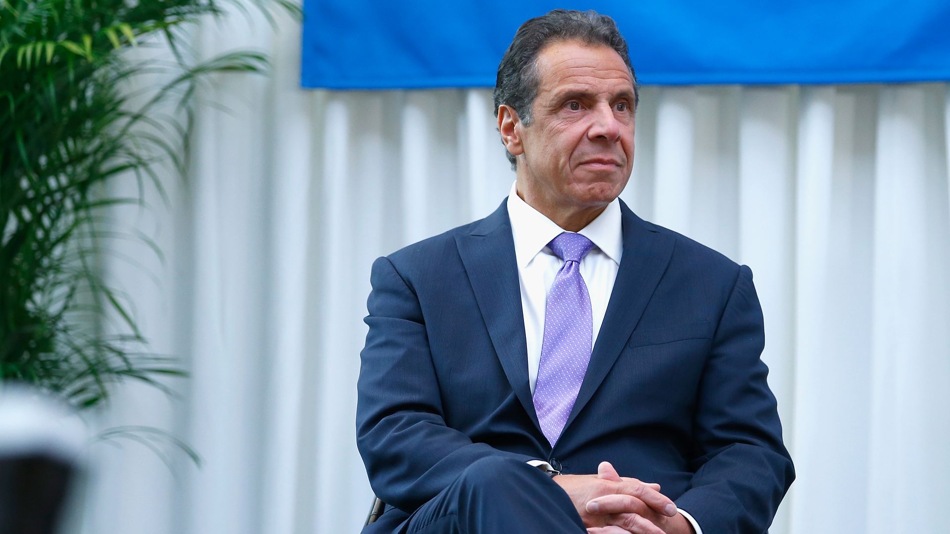 Andrew Cuomo sitting.