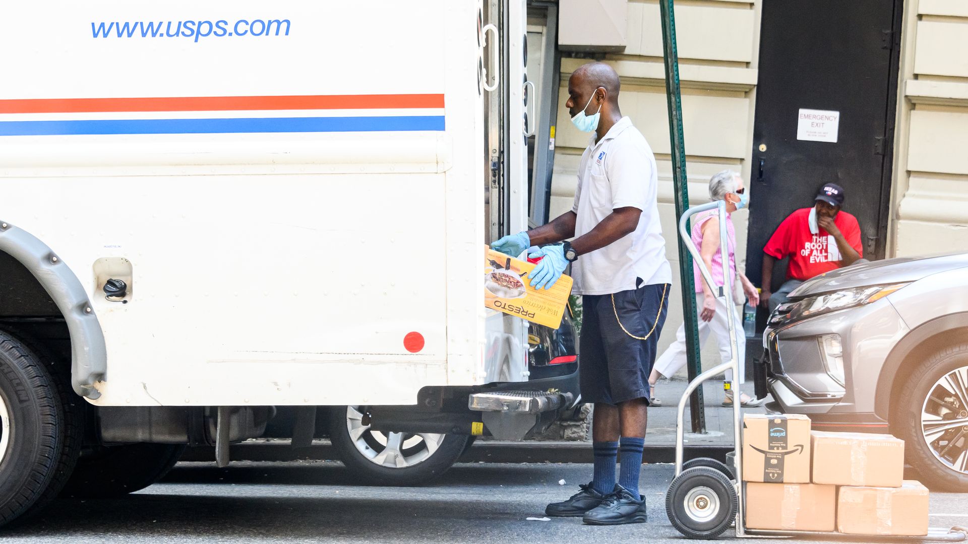 A USPS van and worker