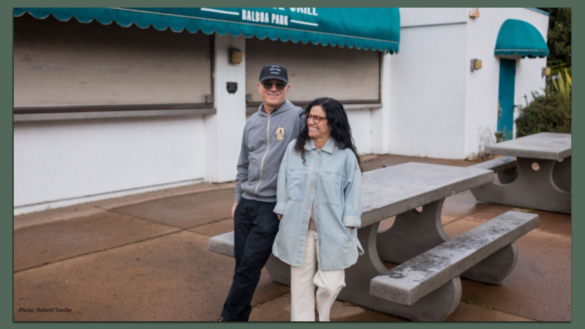 A man and woman stand in front of the old Village Grill at Balboa Park.